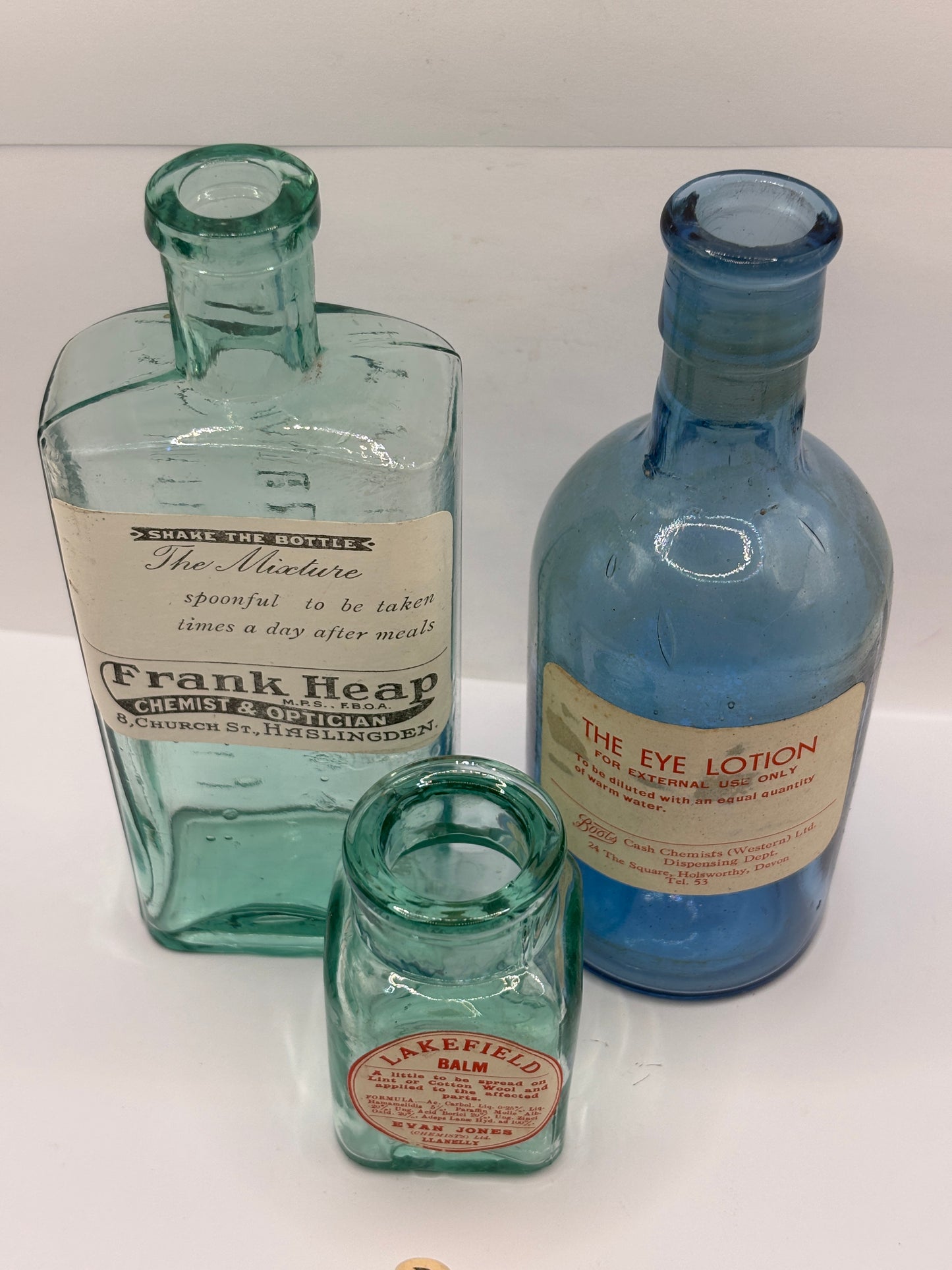3 old glass chemist bottles with added labels