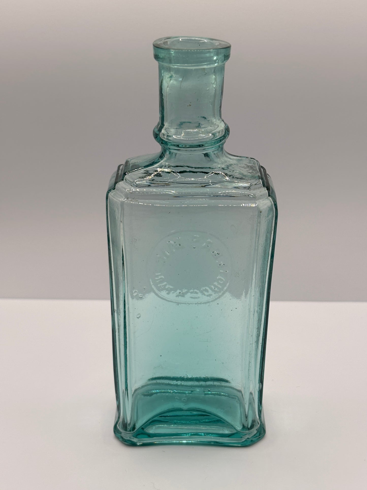 Old aqua glass advertising bottle. Perfume? Erasmic London Paris