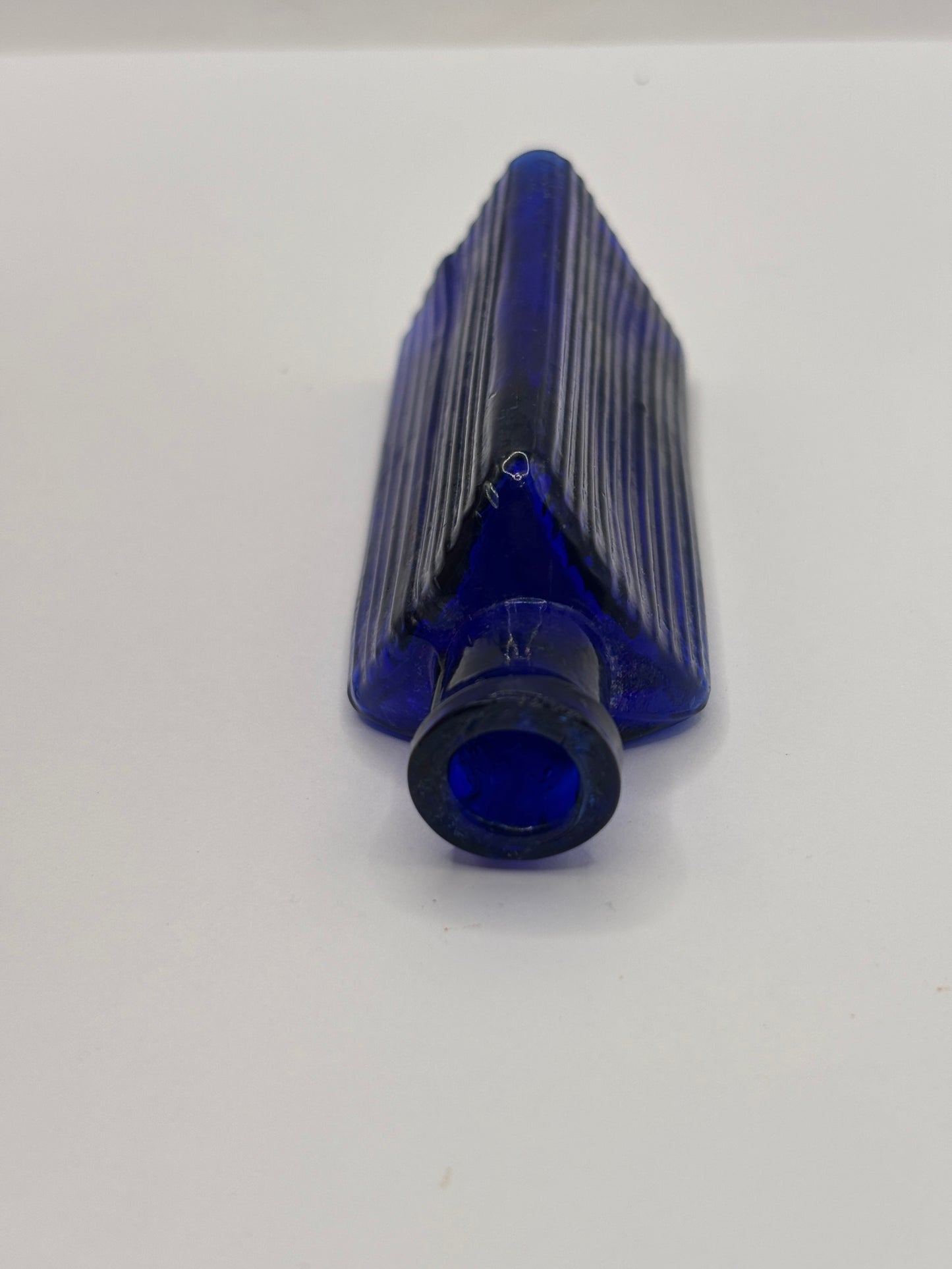 Old small blue triangular poison bottle