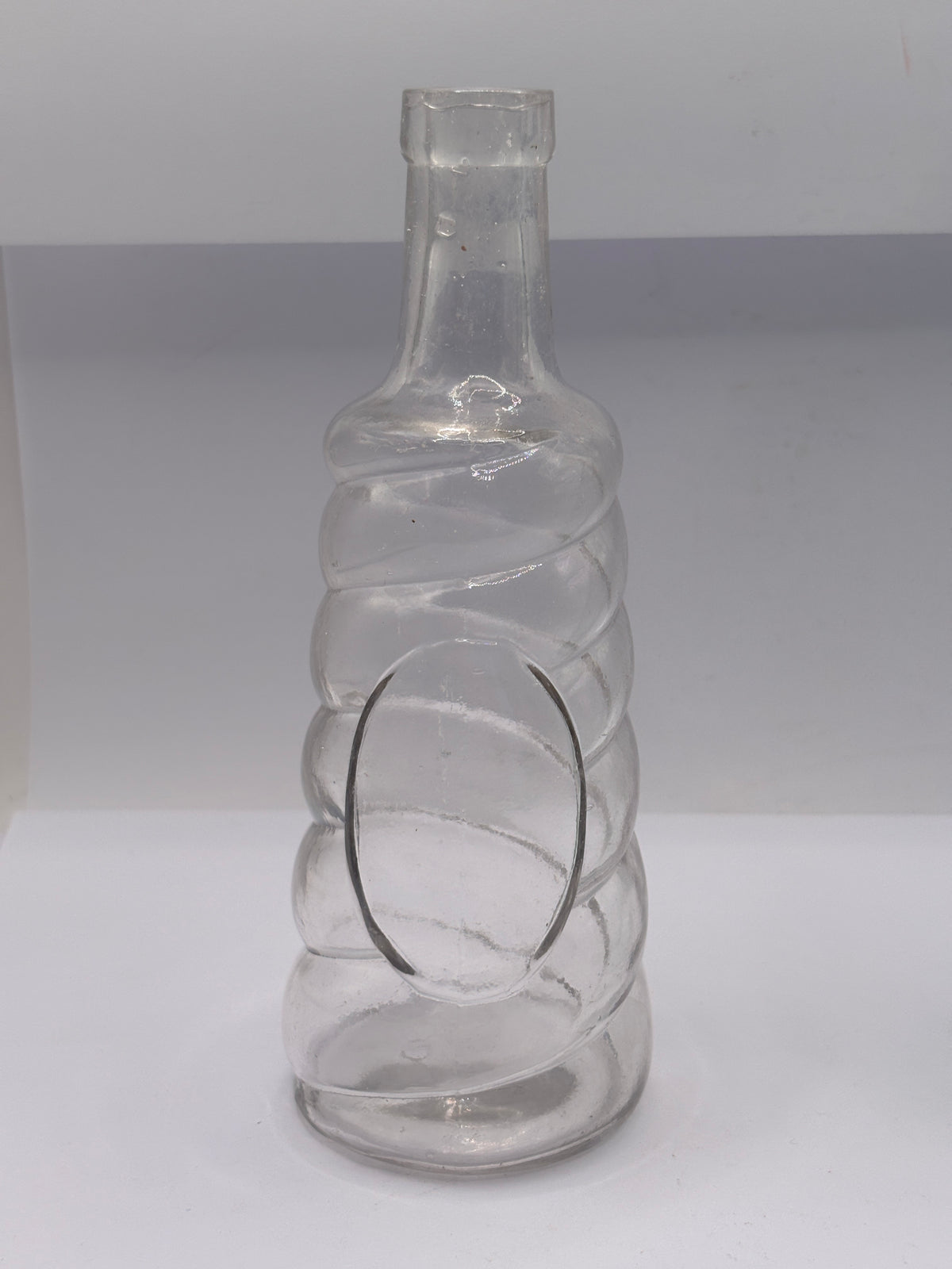 Old clear glass bottle, soda?