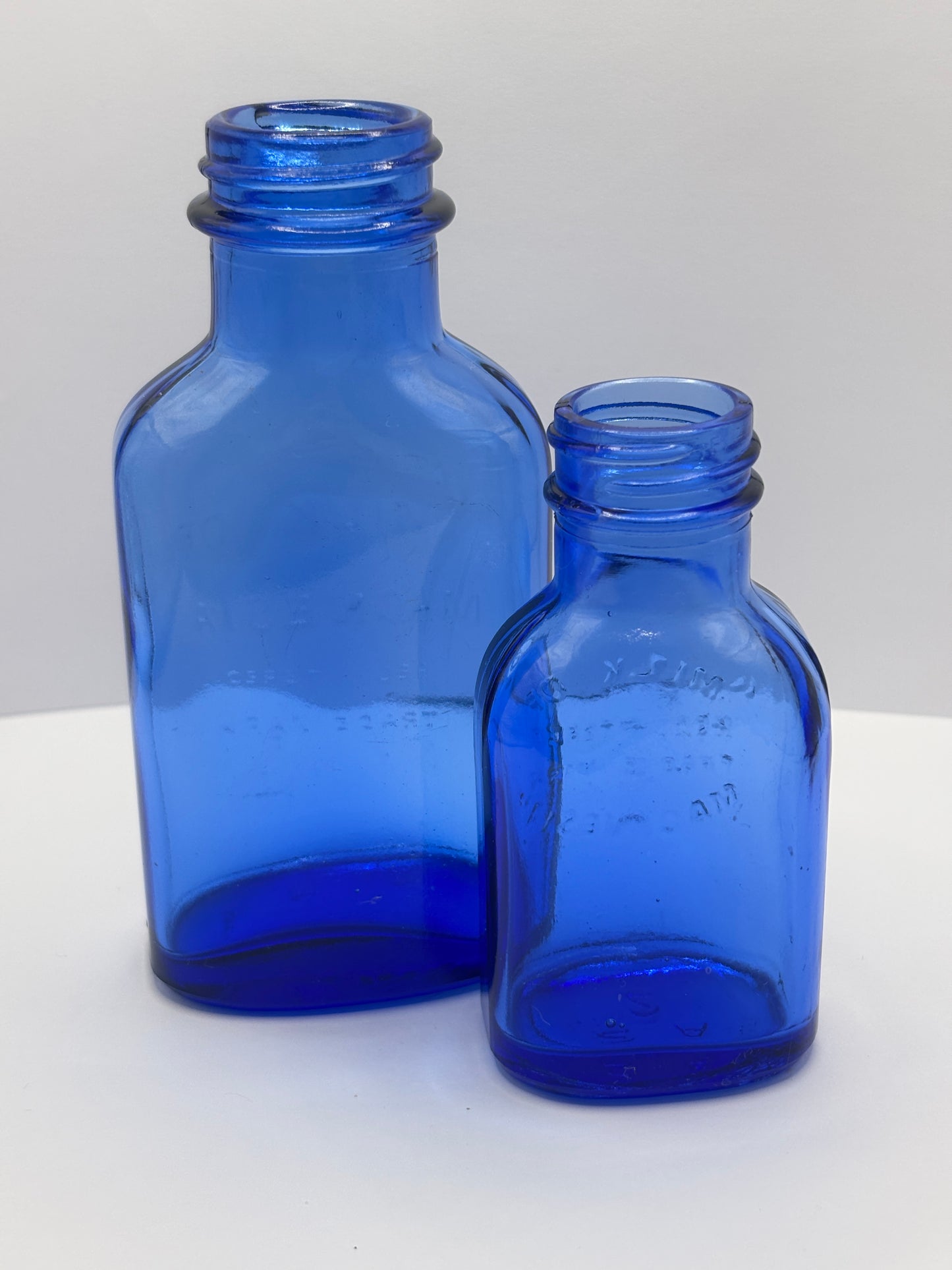 2 Blue milk of magnesia bottles