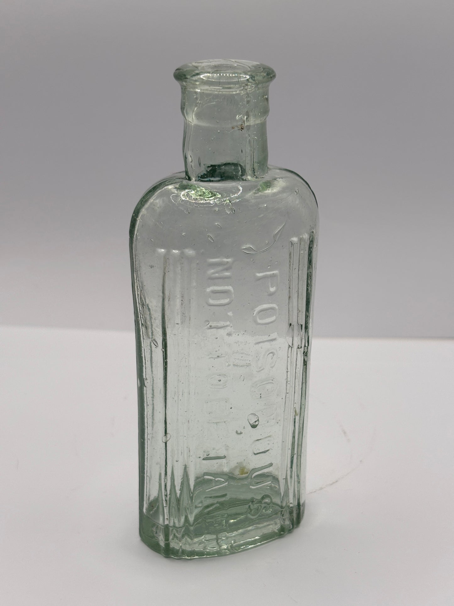 Old aqua glass poison bottle, Poisonous