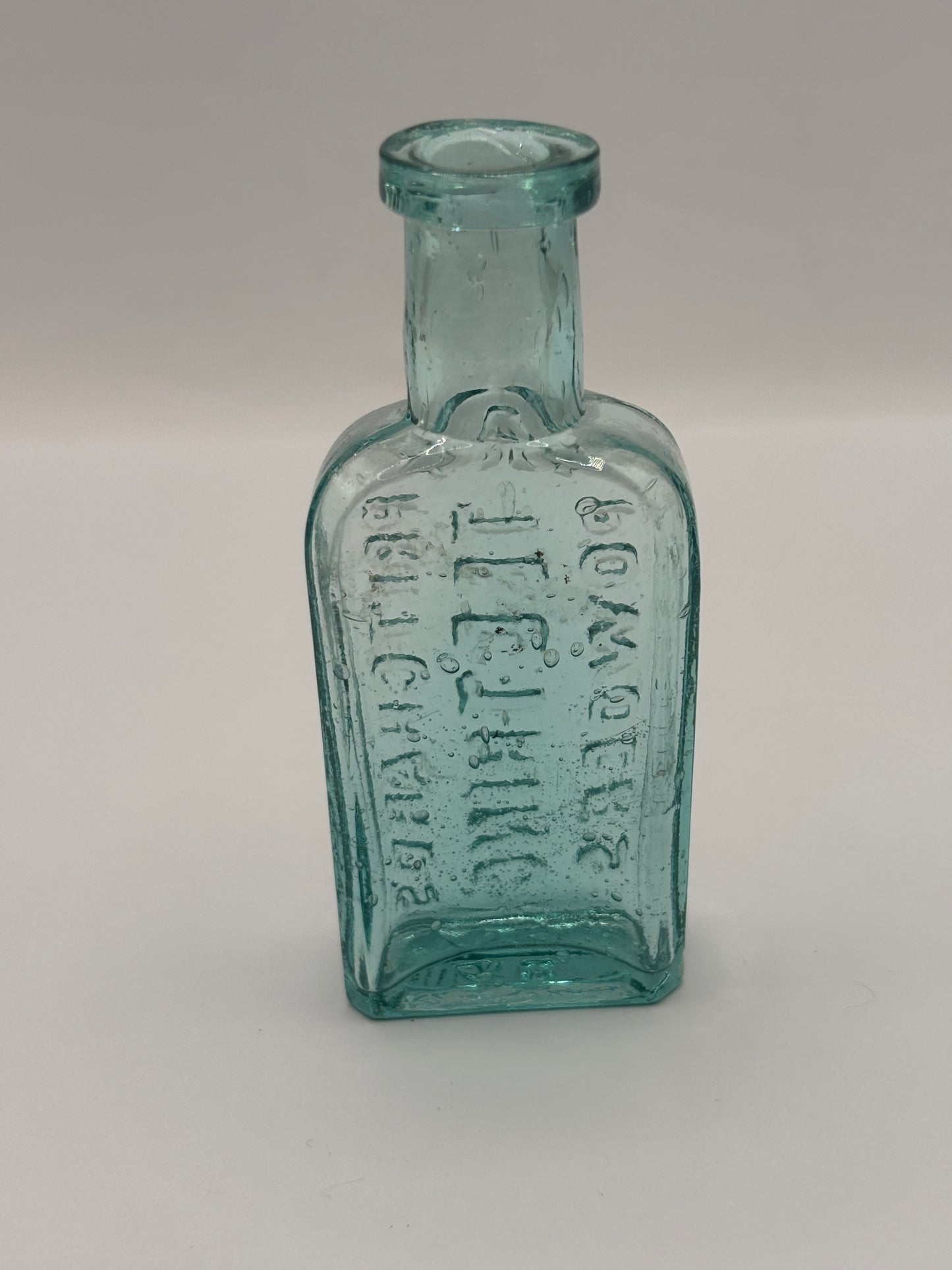 Old small aqua glass advertising bottle. Pritchards teething powders