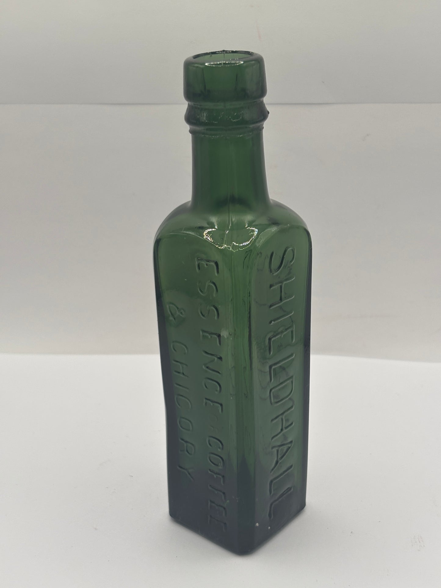 Old green glass essence of coffee & chicory bottle
