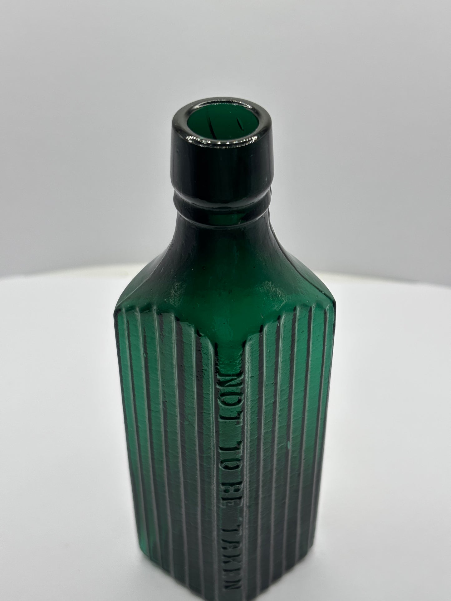 Old green glass poison bottle, not to be taken