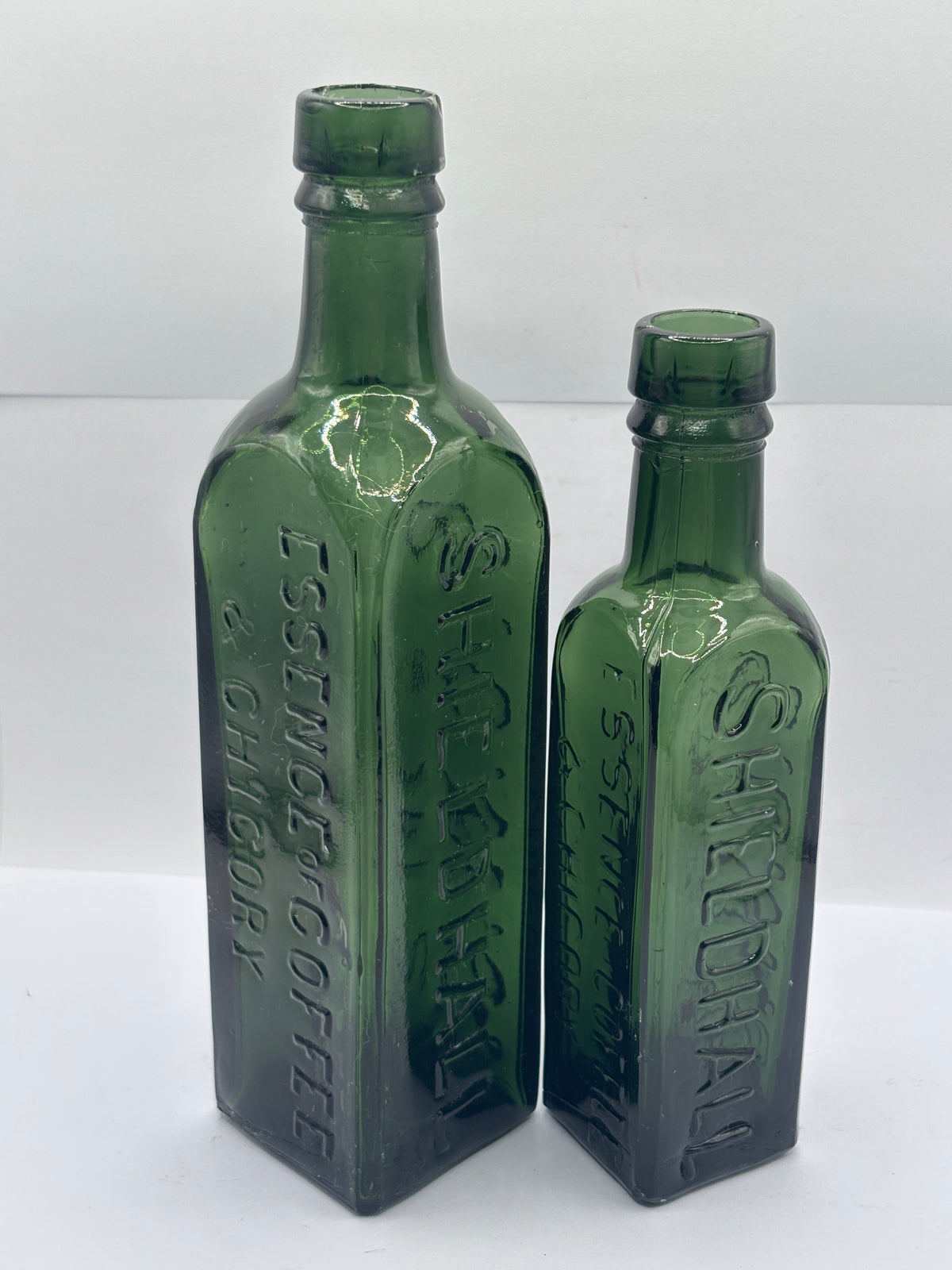 2 Old green glass essence of coffee bottles