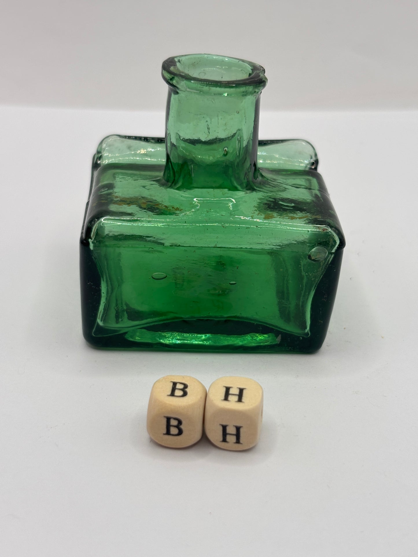 Old green glass ink bottle, inkwell. With pen rest (BH) chipped