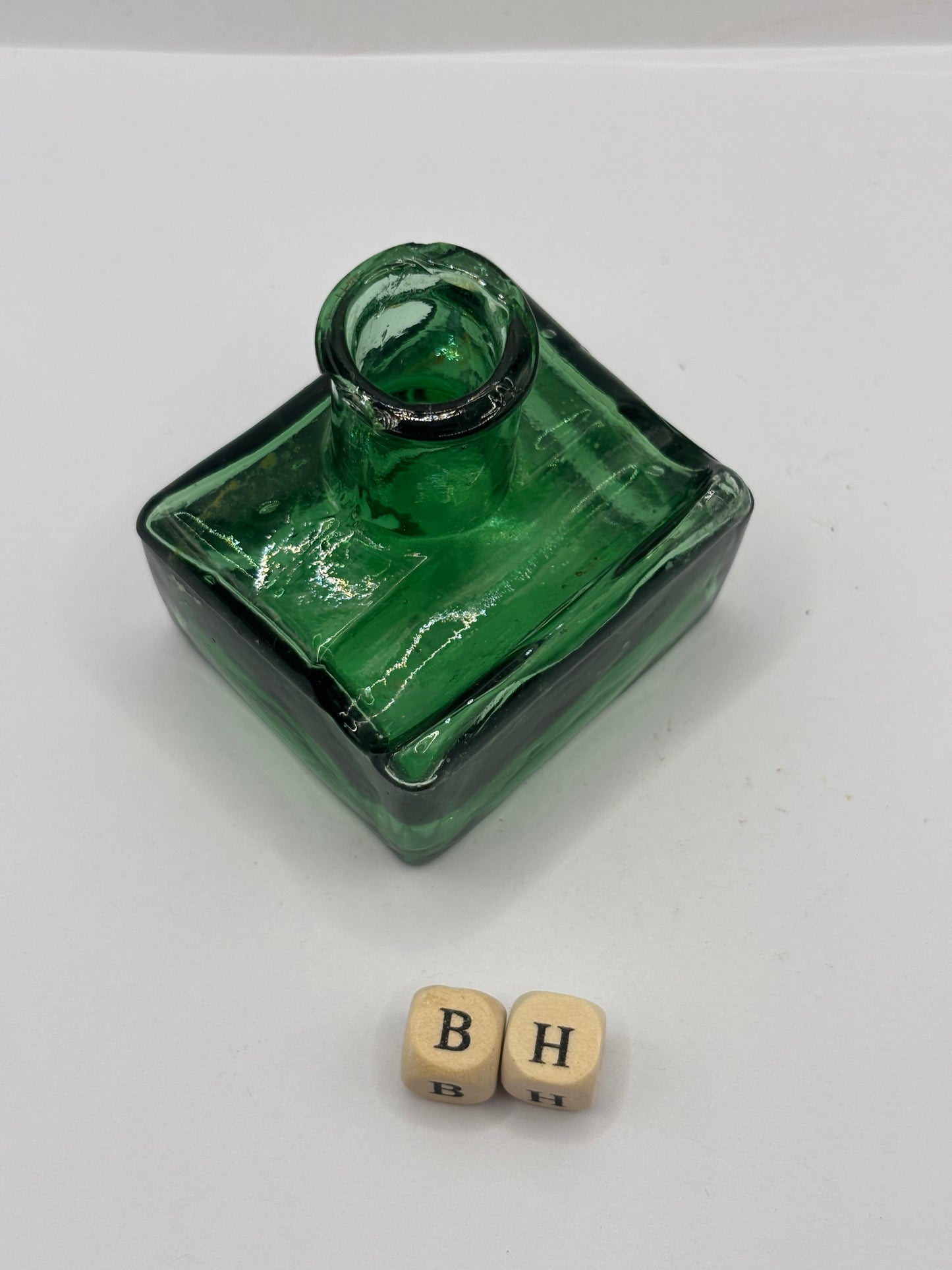 Old green glass ink bottle, inkwell. With pen rest (BH) chipped
