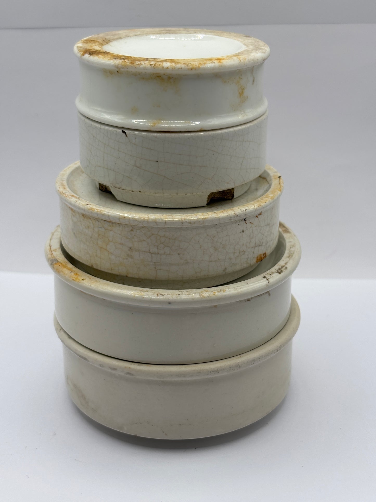 5 plain stoneware bases, stackers. Chipped