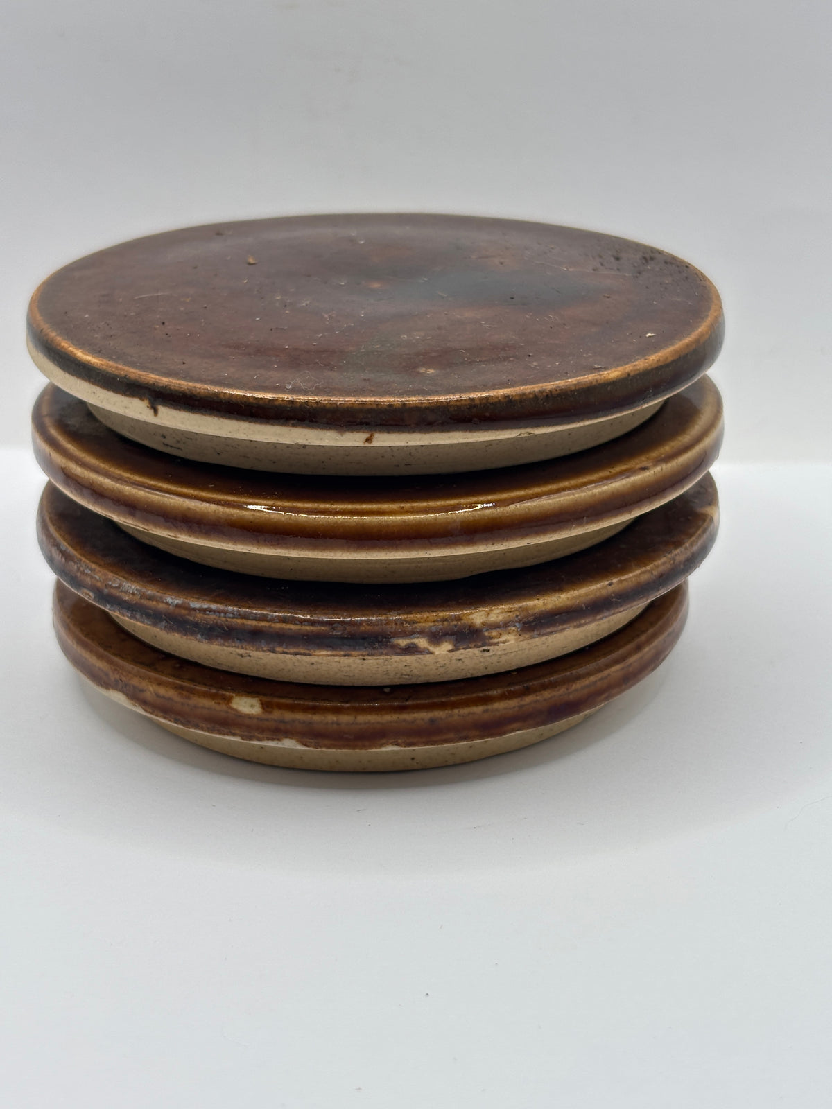 4 old brown stoneware lids, stackers