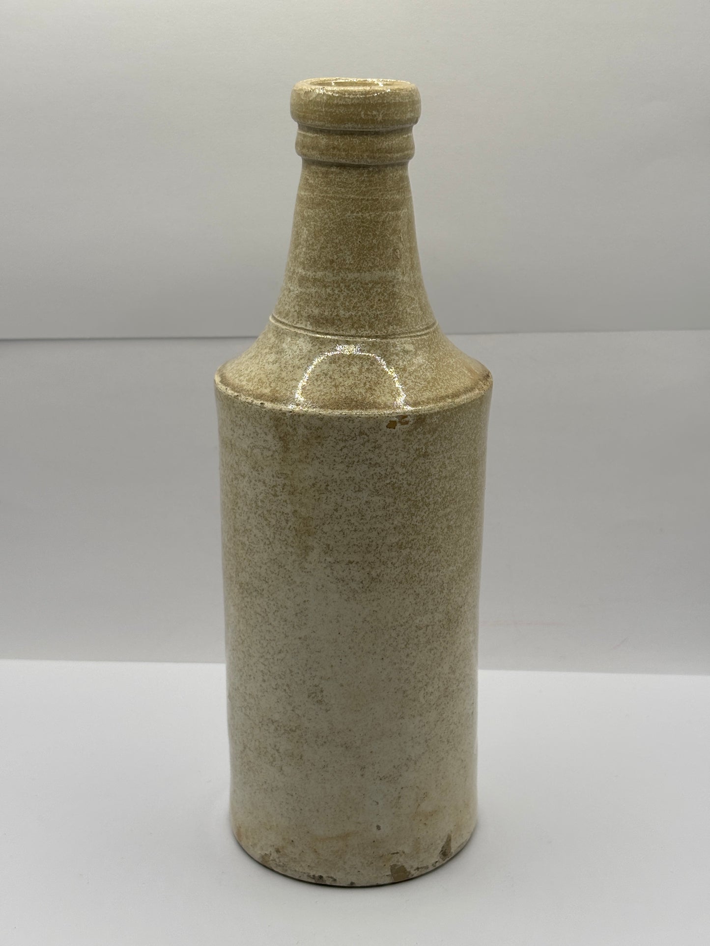 Old tall white stoneware porter bottle
