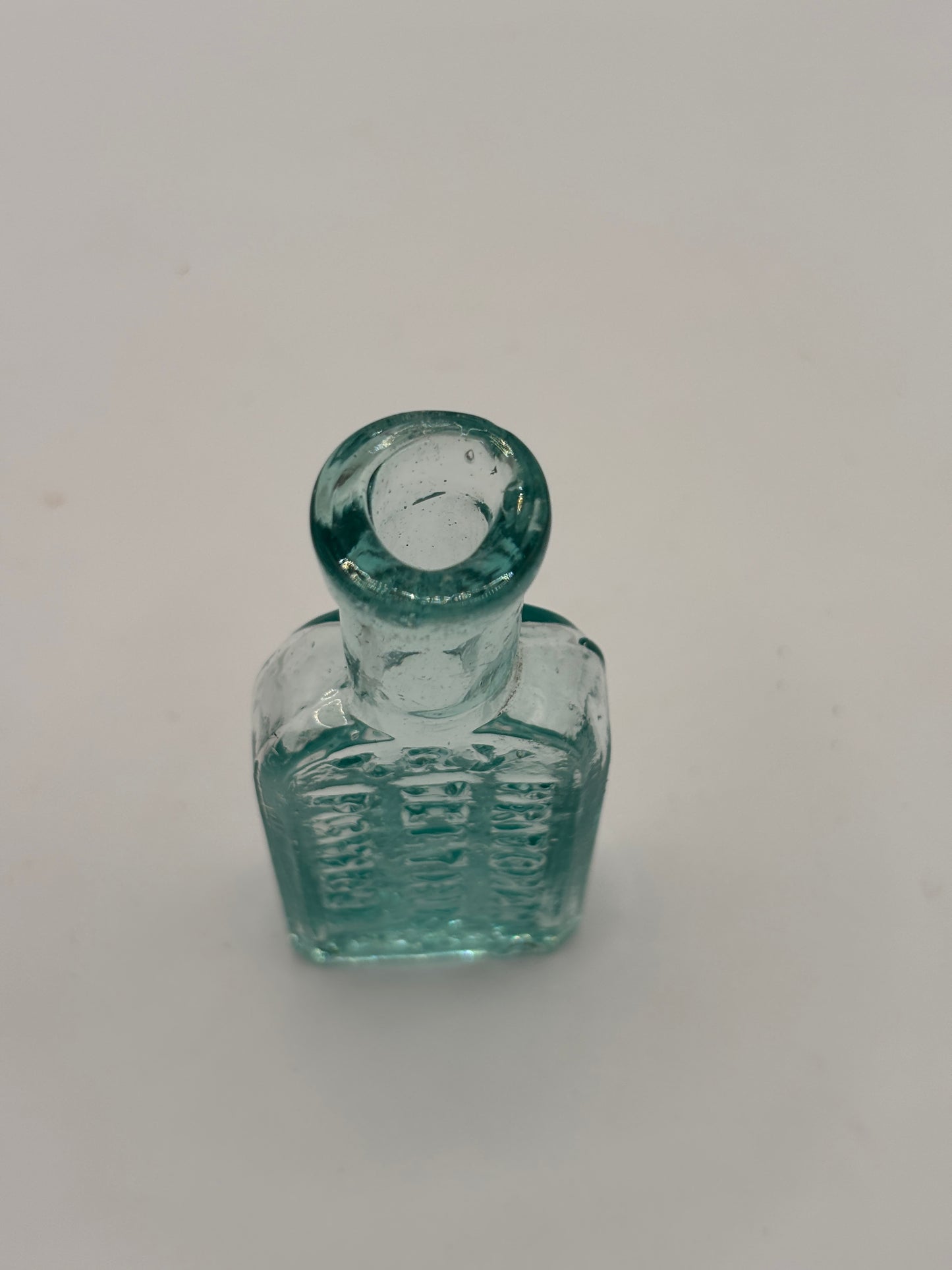 Old small aqua glass advertising bottle. Pritchards teething powders
