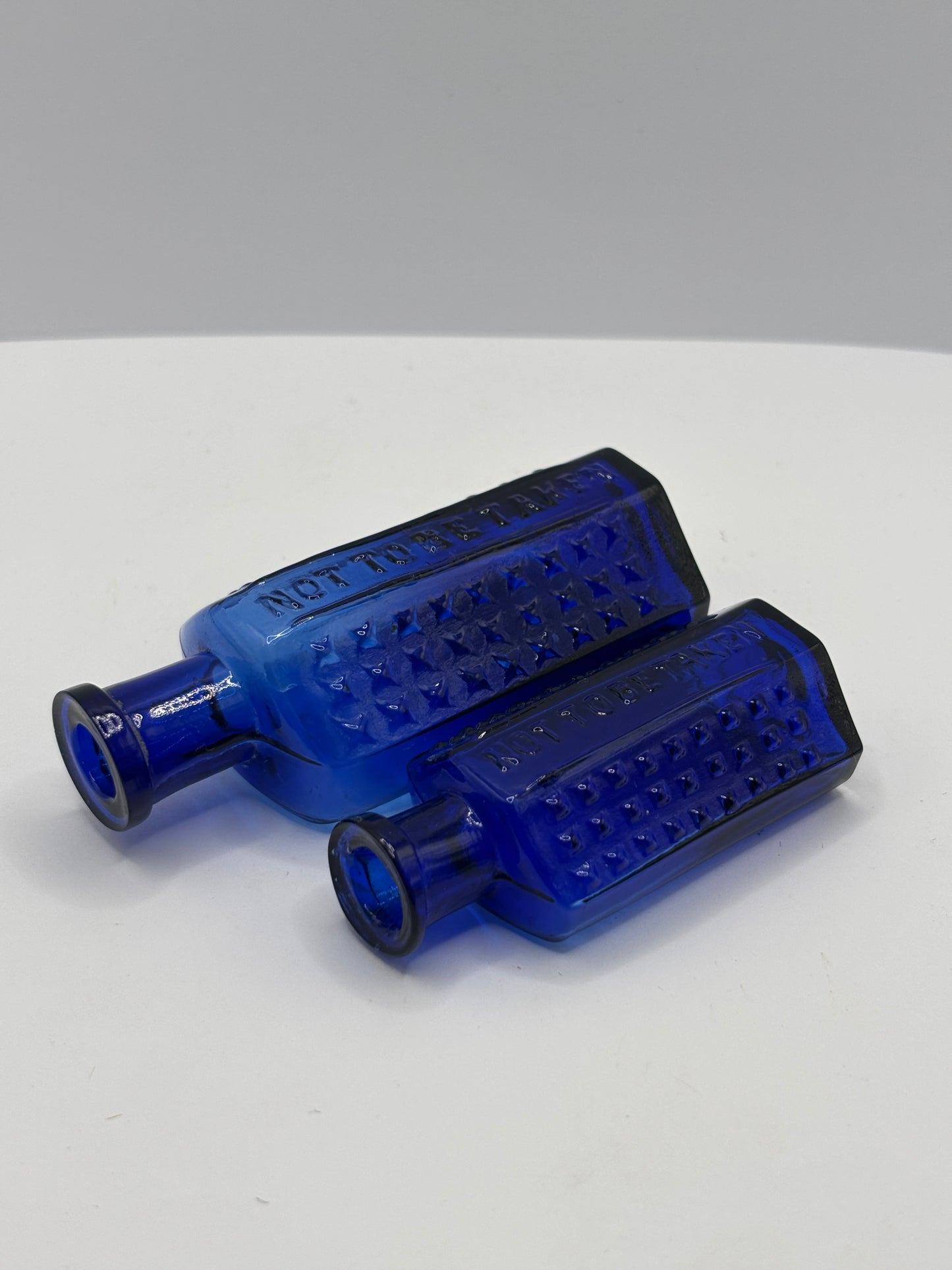 2 old blue flat back poison bottles