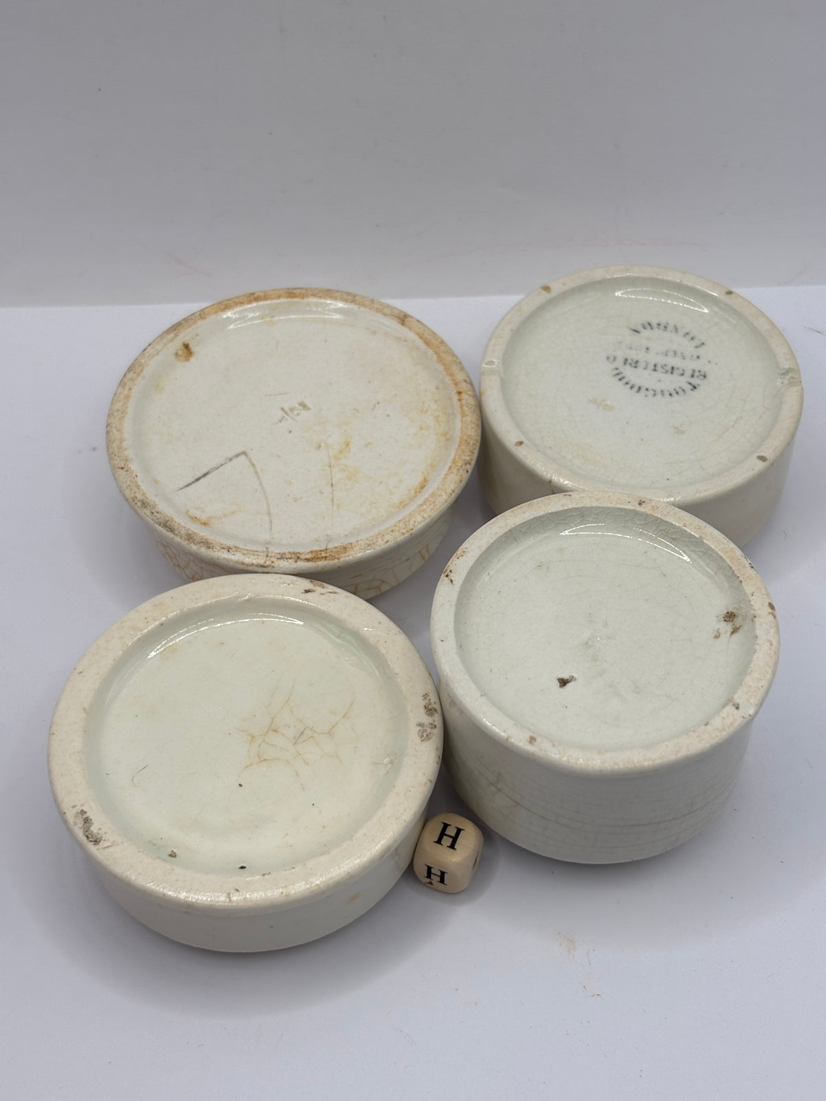 4 old stoneware pot lid bases, stackers (H)