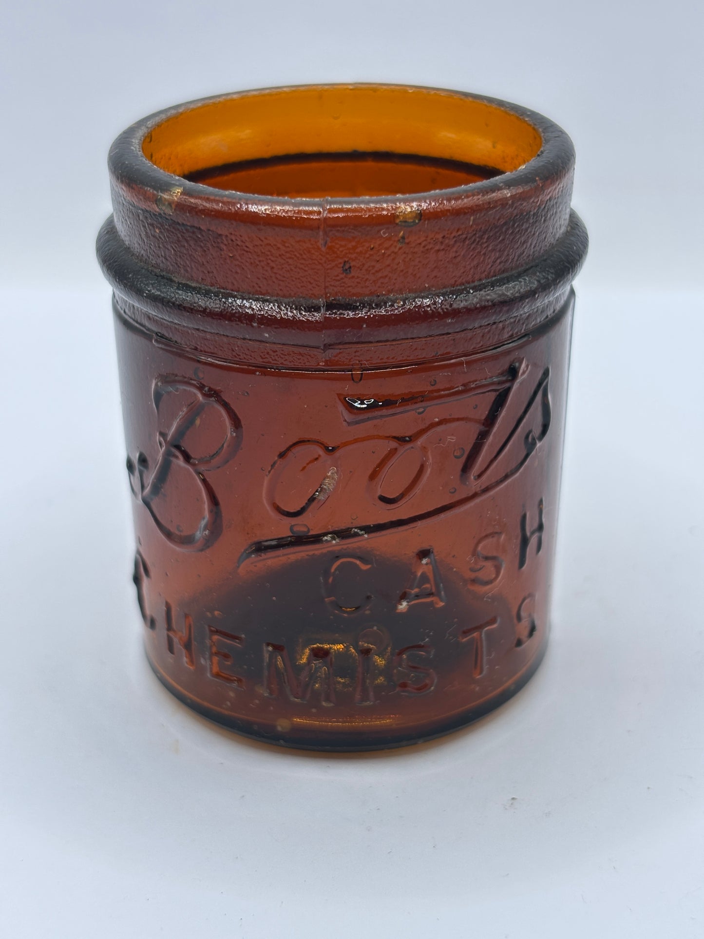Small old amber glass boots jar