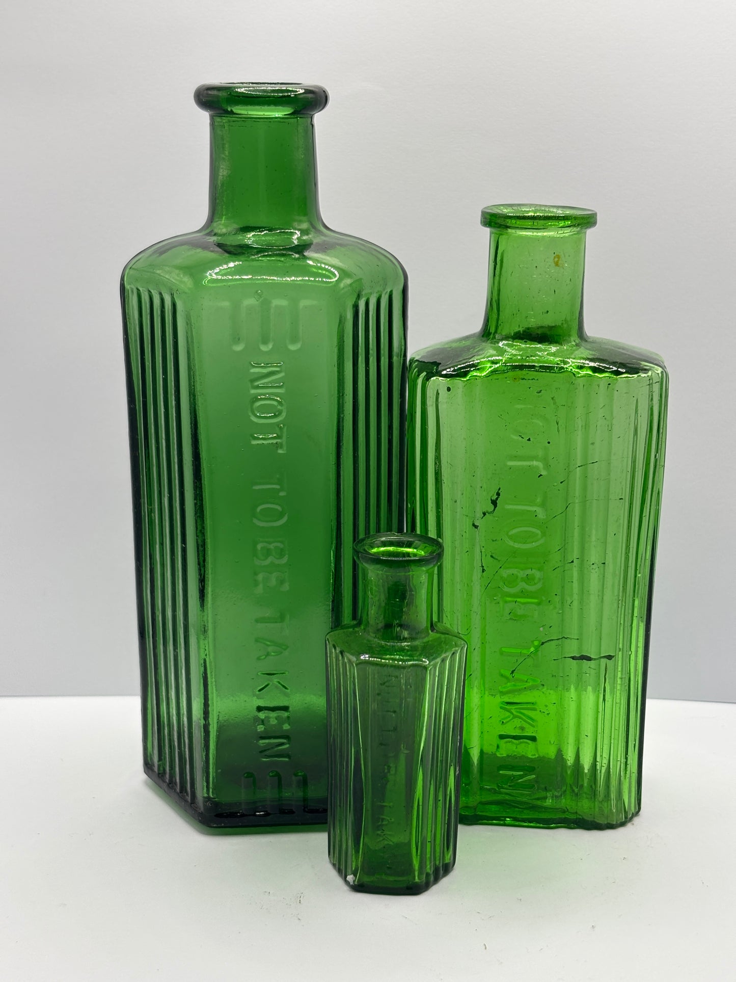 3 old green glass poison bottles, not to be taken