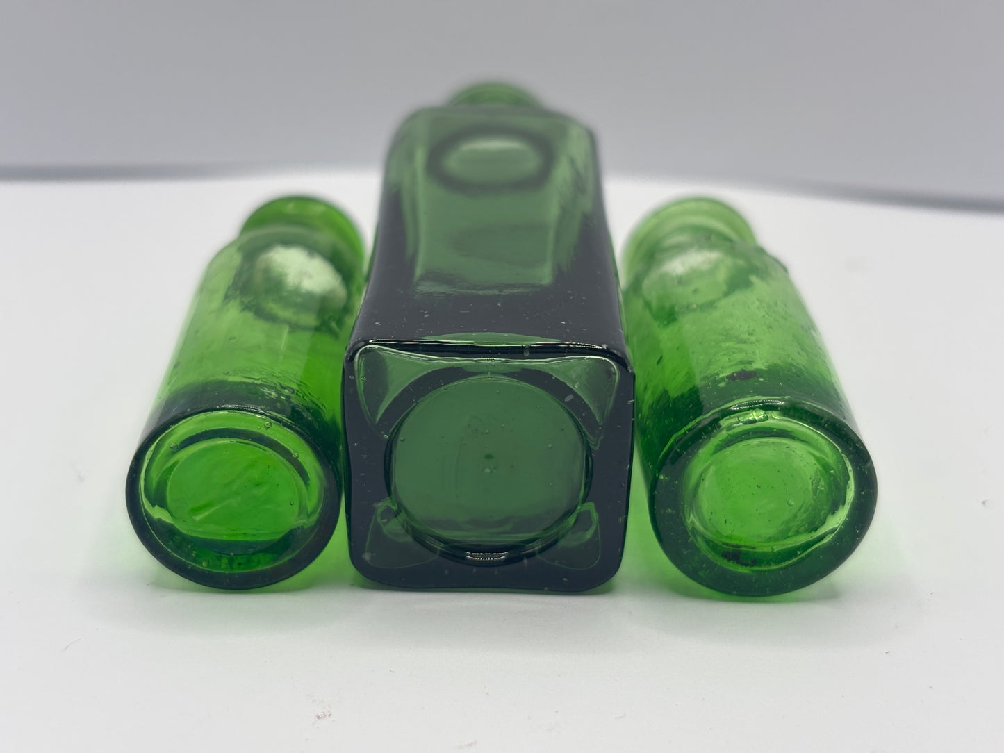 3 old green glass bottles