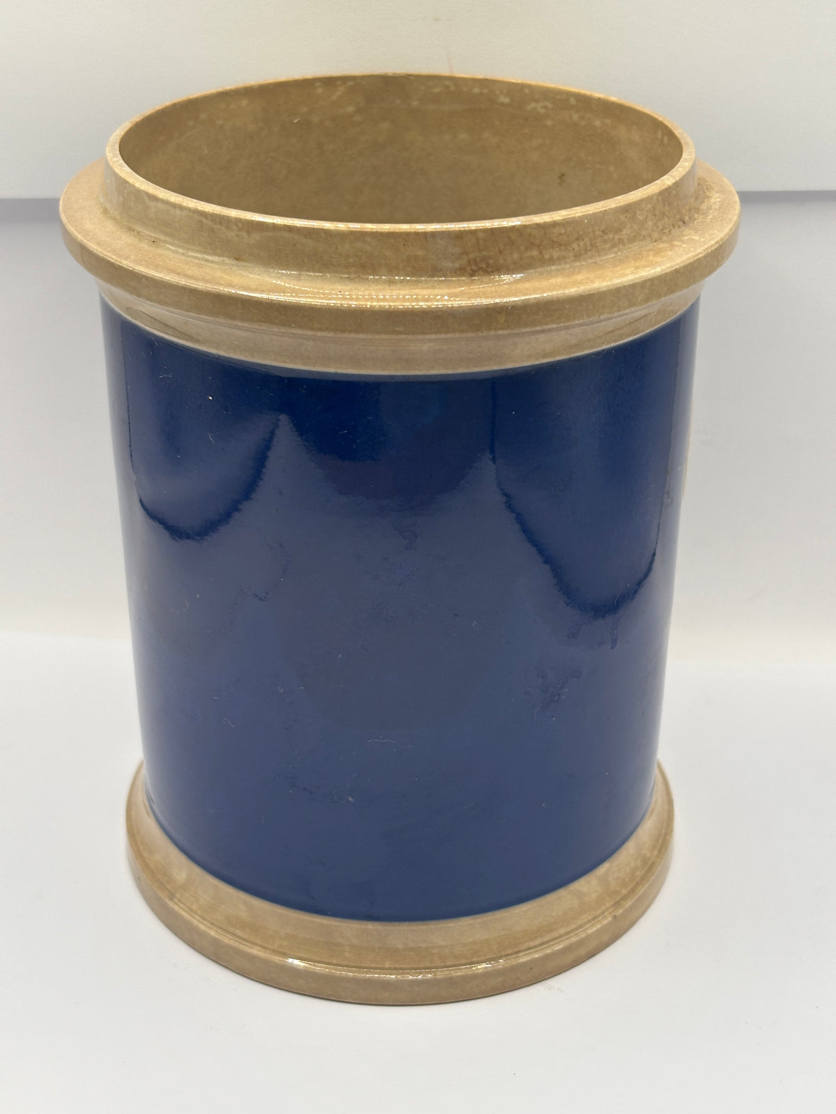 Old plain blue stoneware apothecary jar with glass label