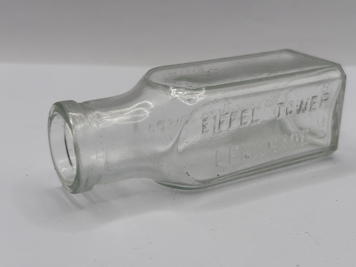 Old clear glass Eiffel tower lemonade bottle
