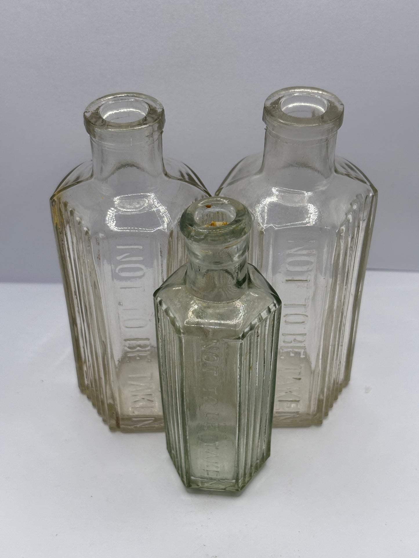 3 Old clear glass poison bottles, not to be taken