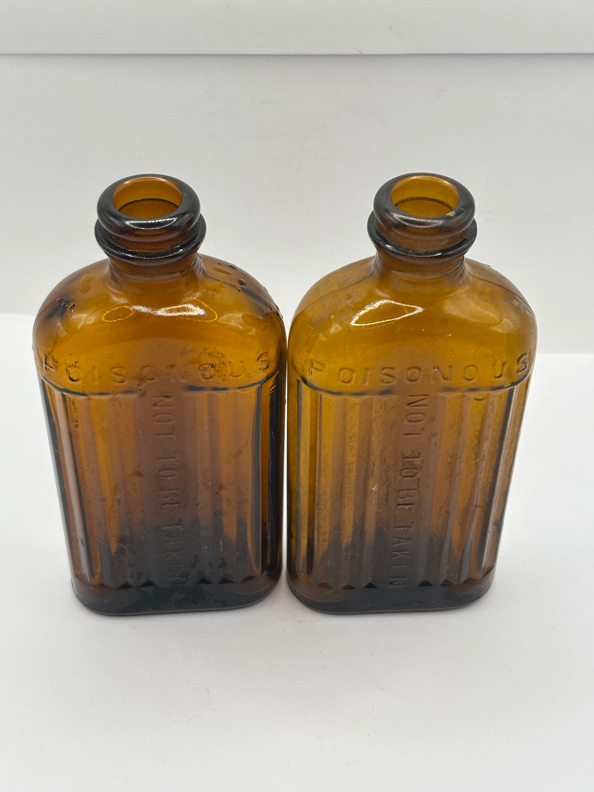 2 old amber glass ribbed poison bottes, not to be taken