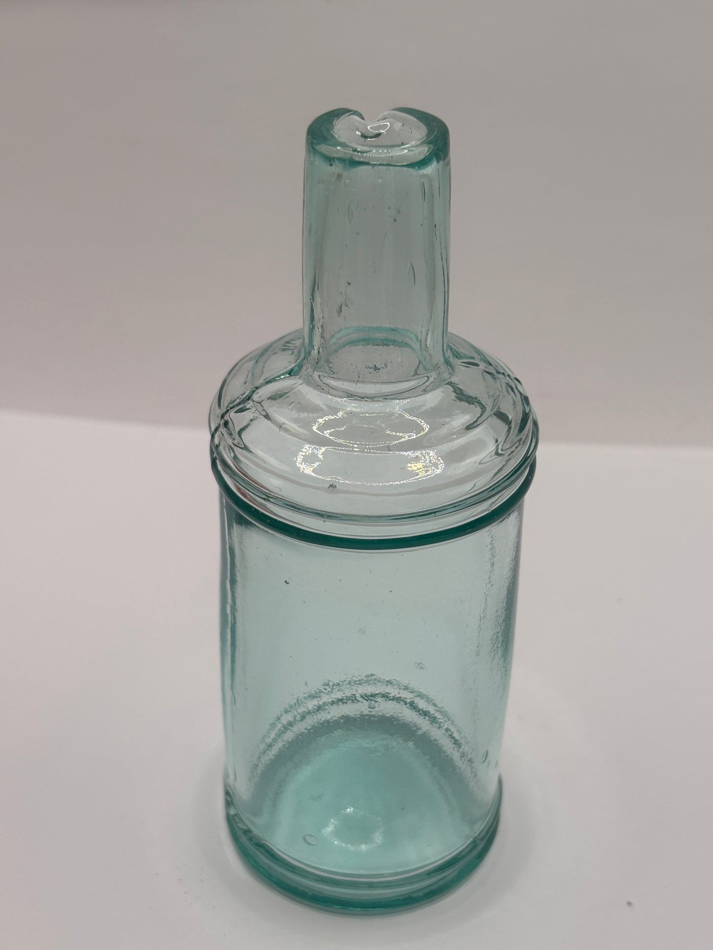 Old tall aqua glass pouring ink, inkwell