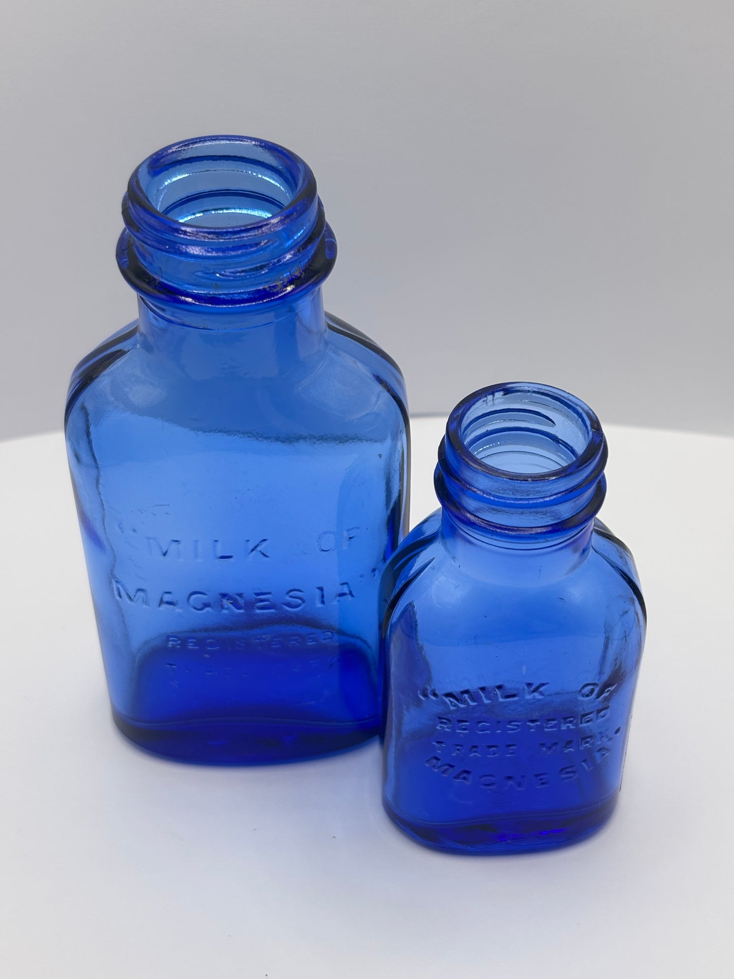 2 Blue milk of magnesia bottles