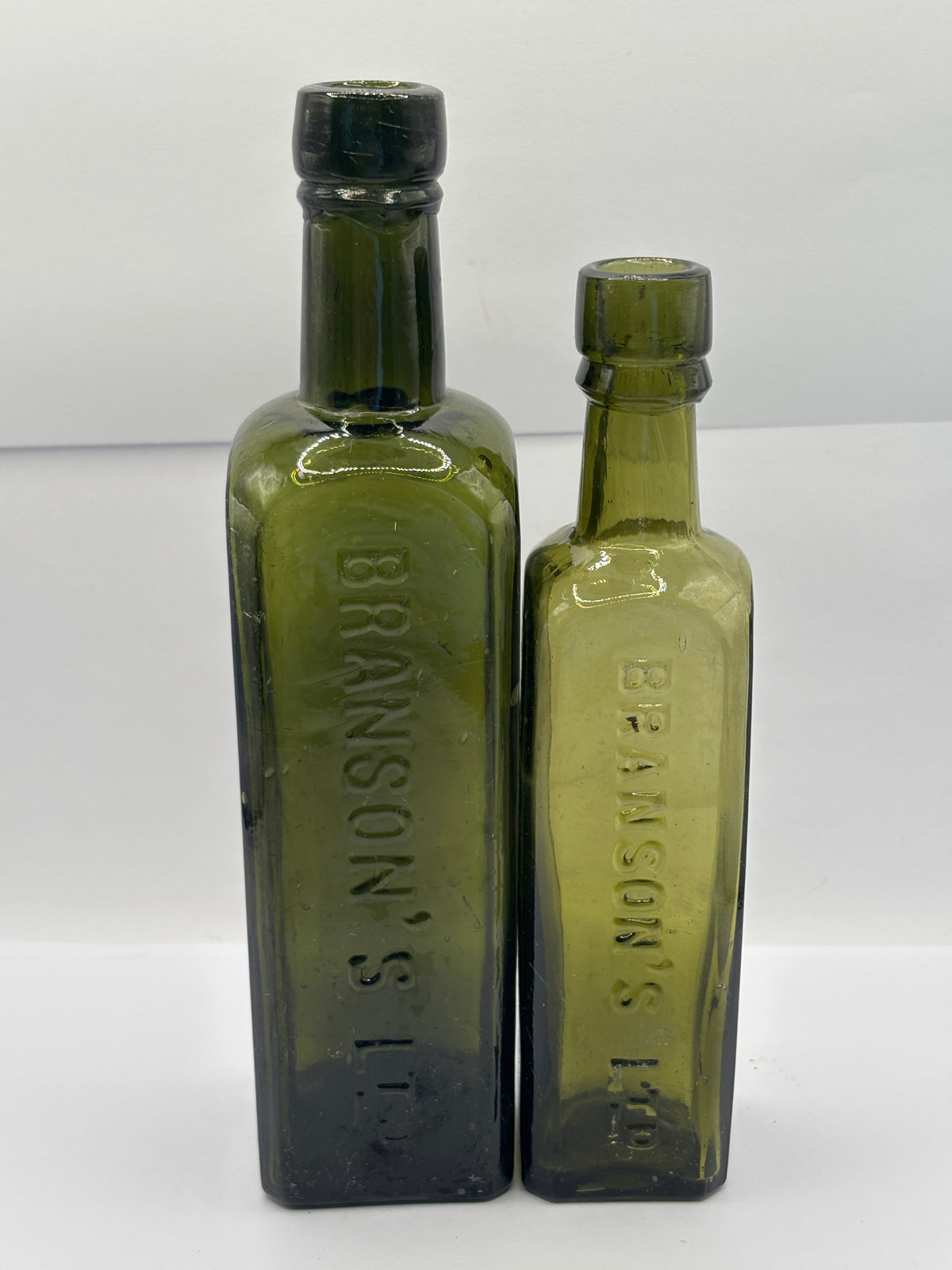 2 Old green glass Branston sauce bottles