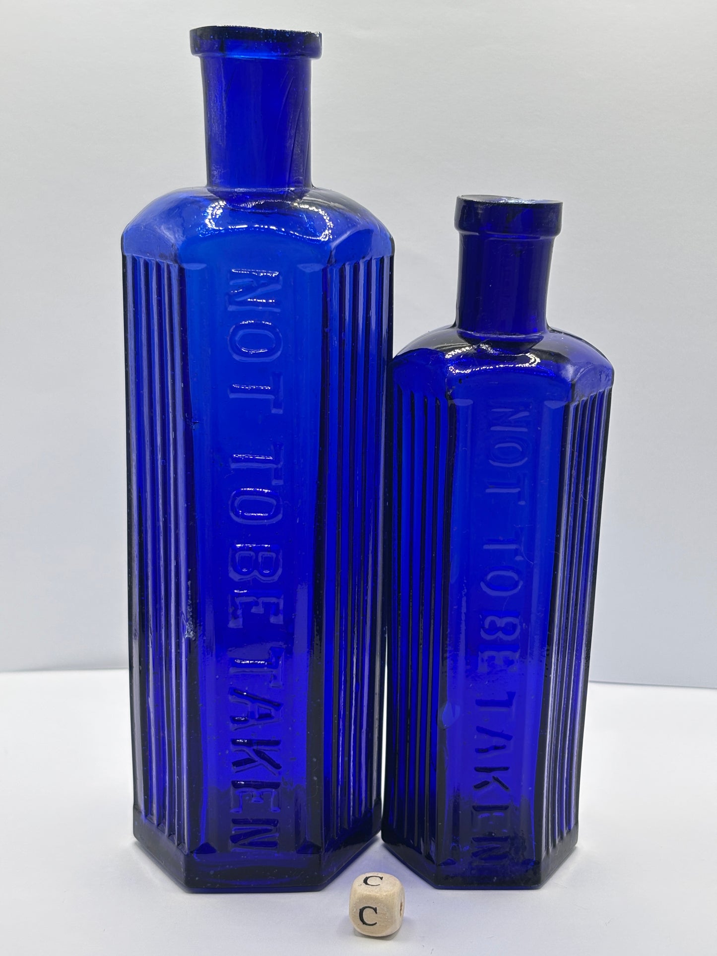 2 Old blue glass ribbed poison bottles. ‘not to be taken’ (C) damaged