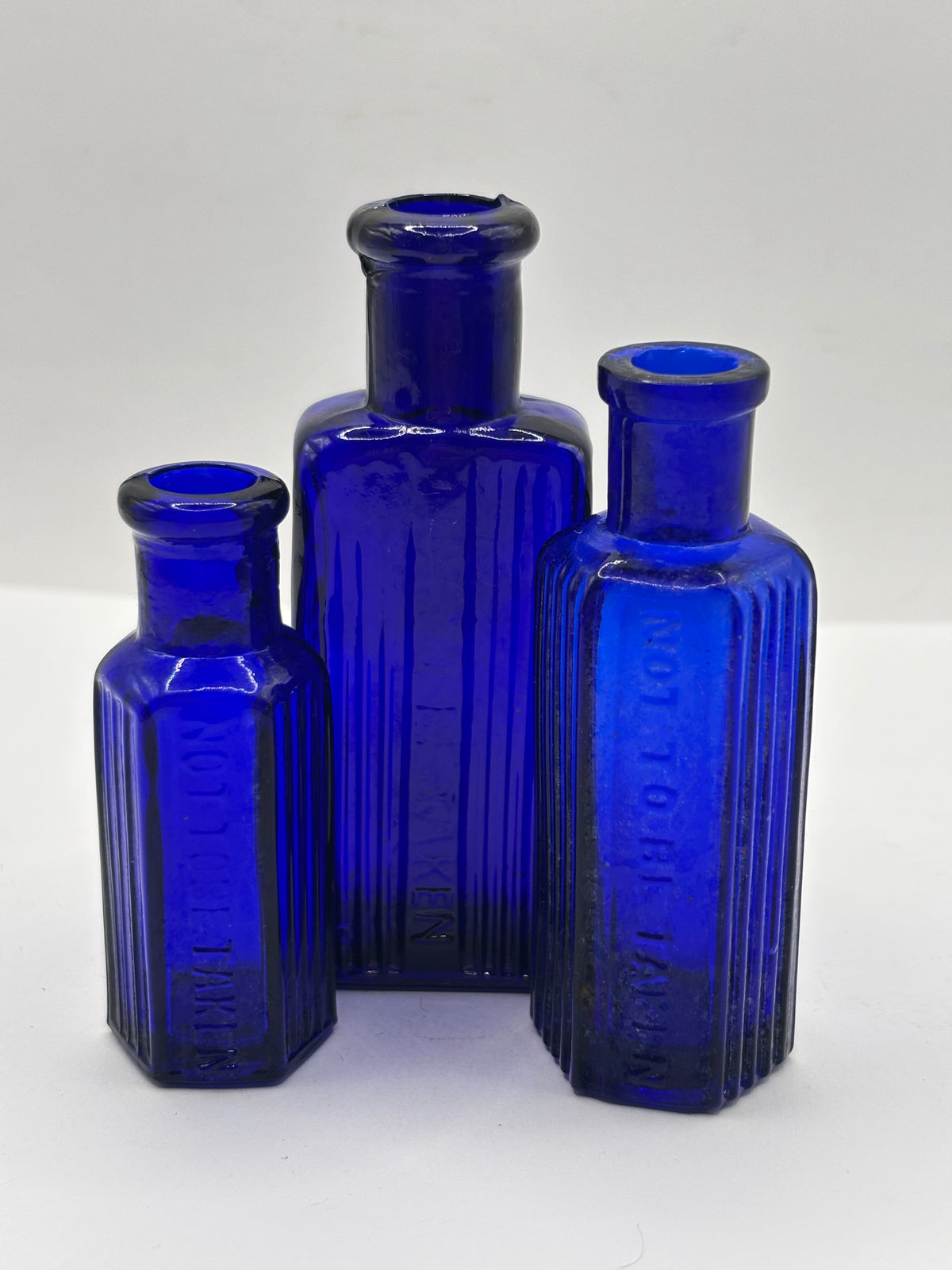 3 old small blue ribbed poison bottles, not to be taken