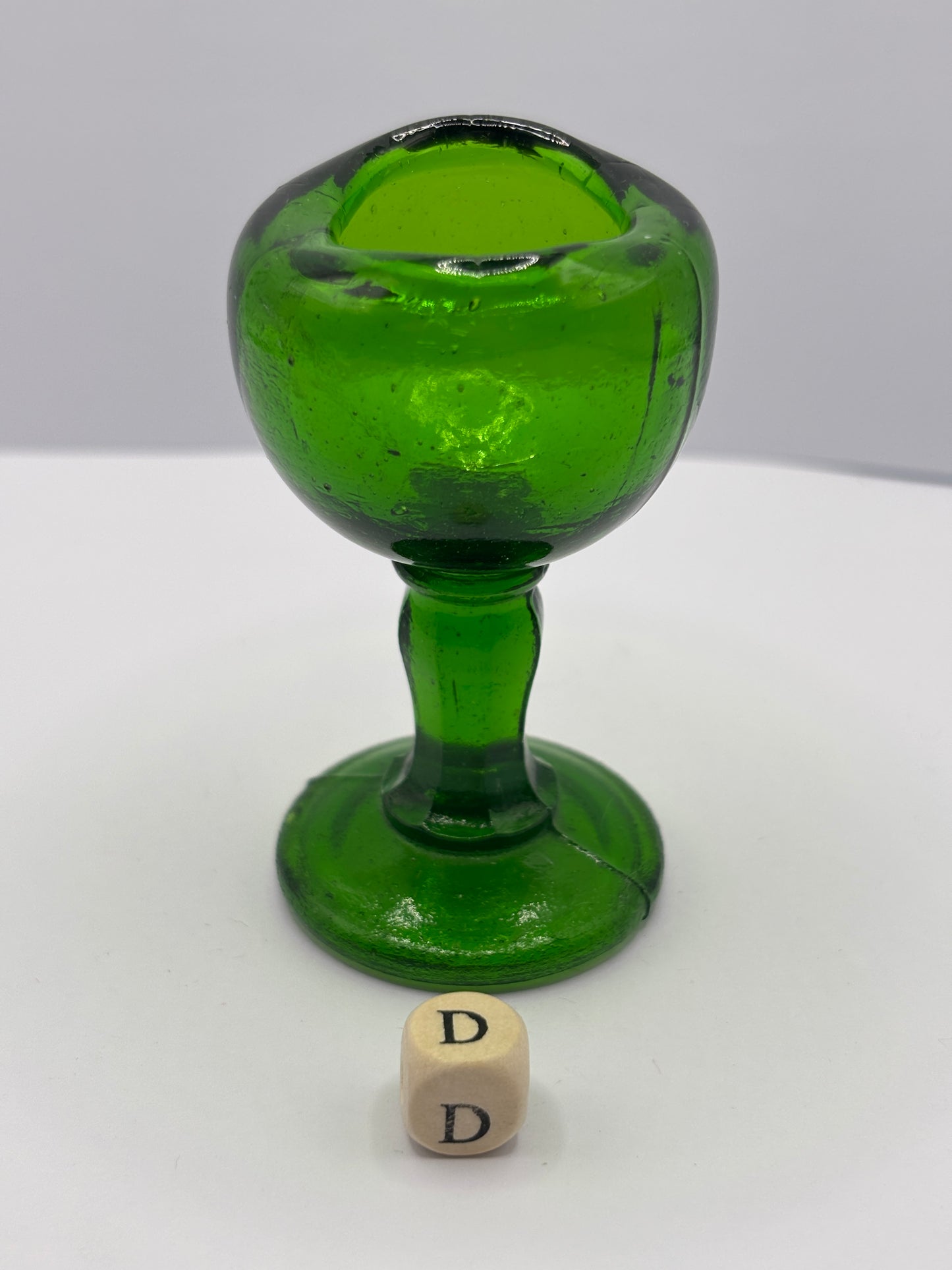 Old green glass eye bath (D)