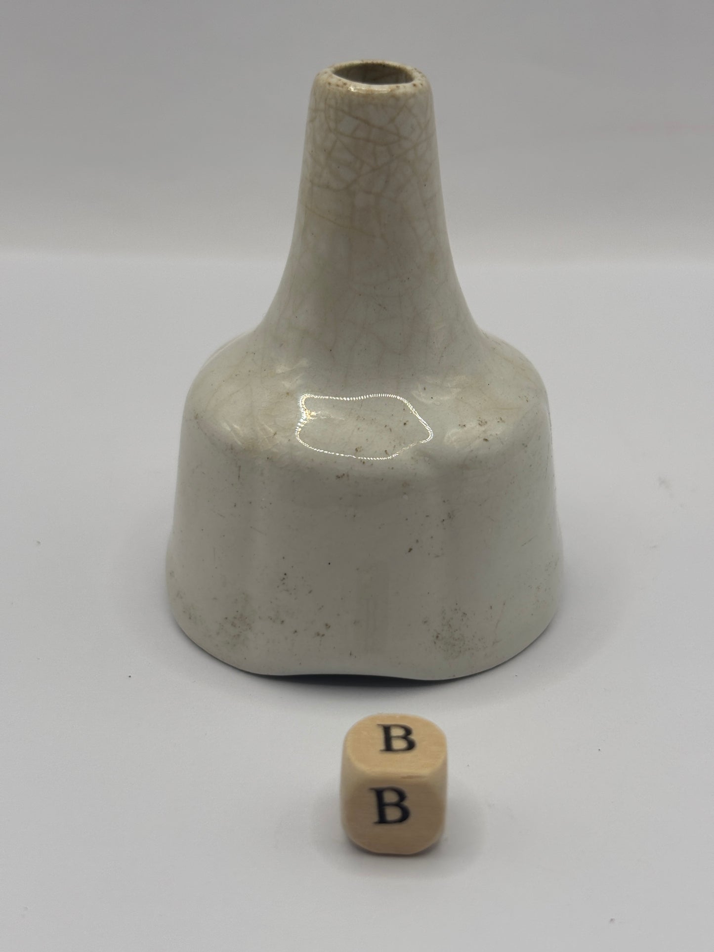 Old white stoneware pie funnel, stained & crazed. Chipped