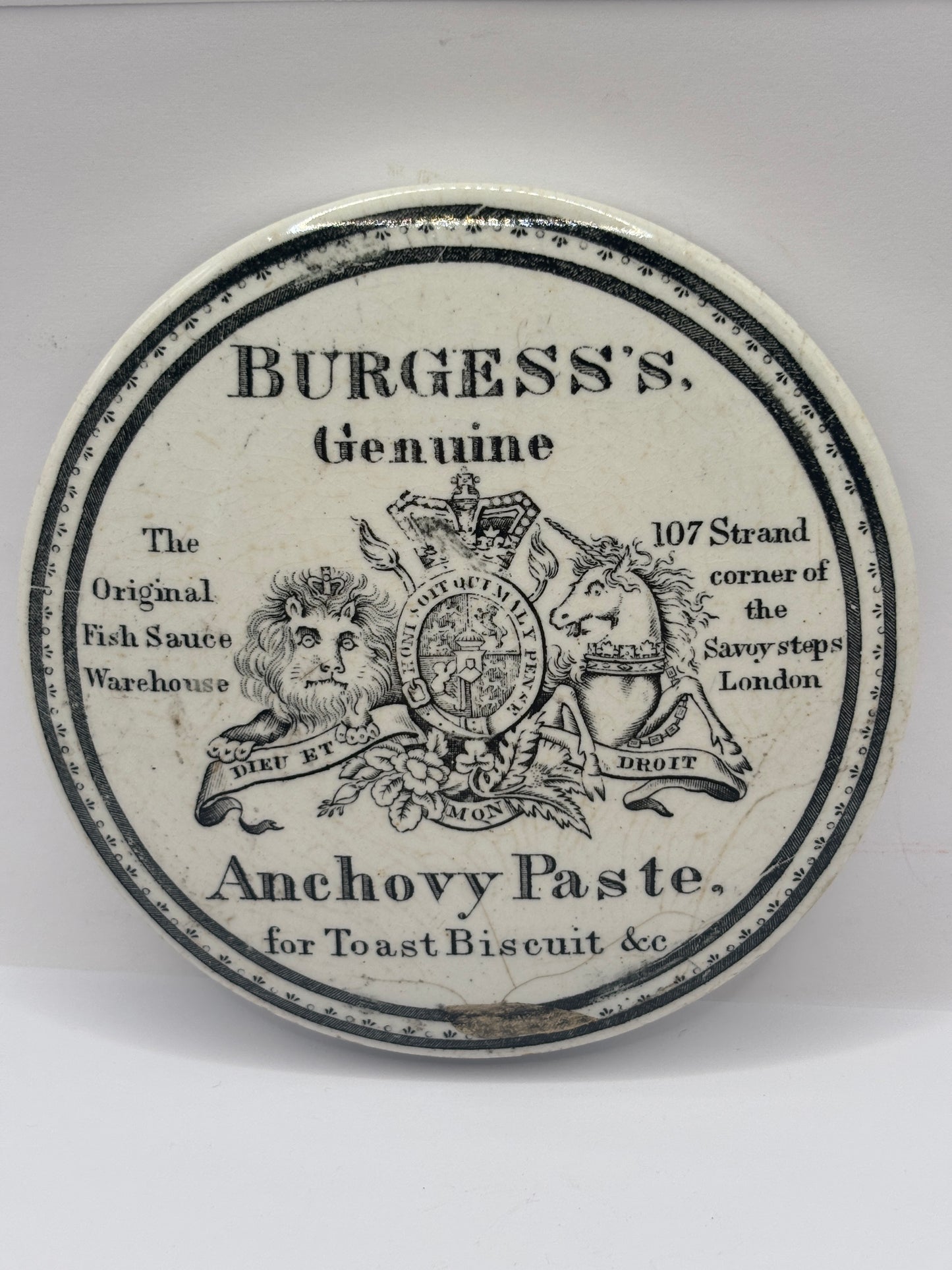 Old early advertising lid, large Burgess anchovy paste. Repaired