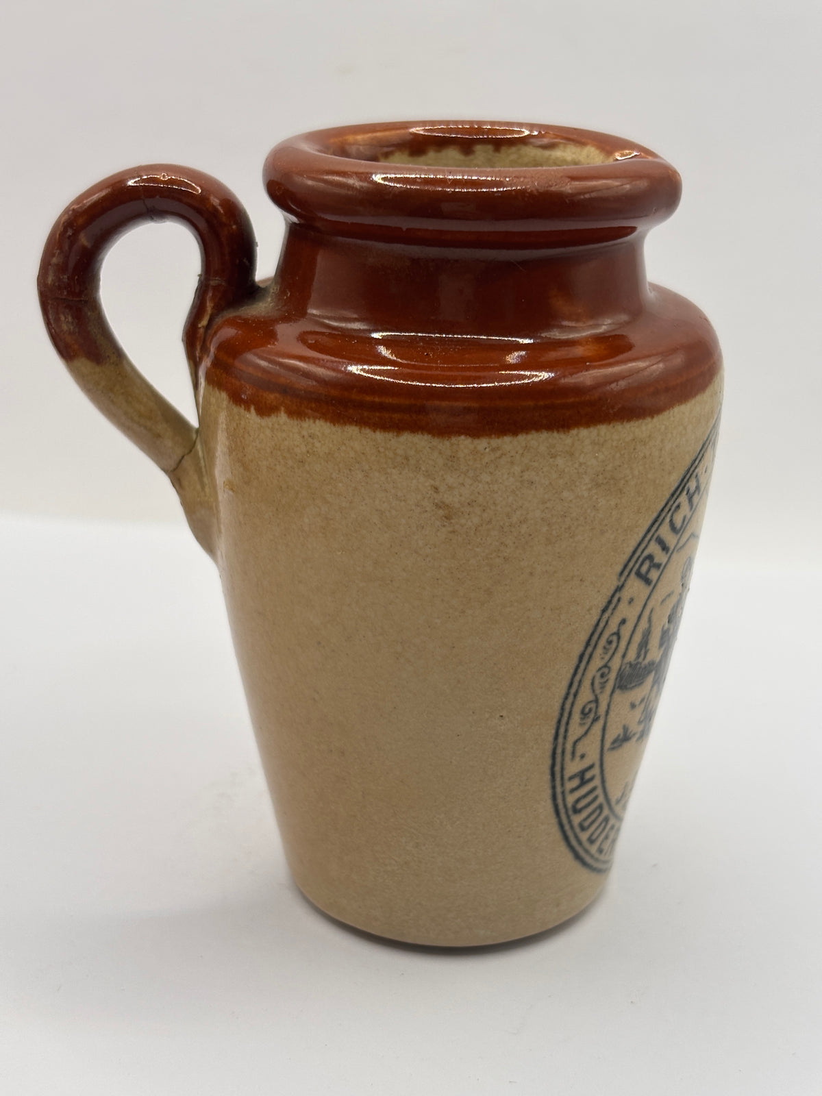 Old advertising cream pot, Bannisters Huddersfield dairies. Repaired handle