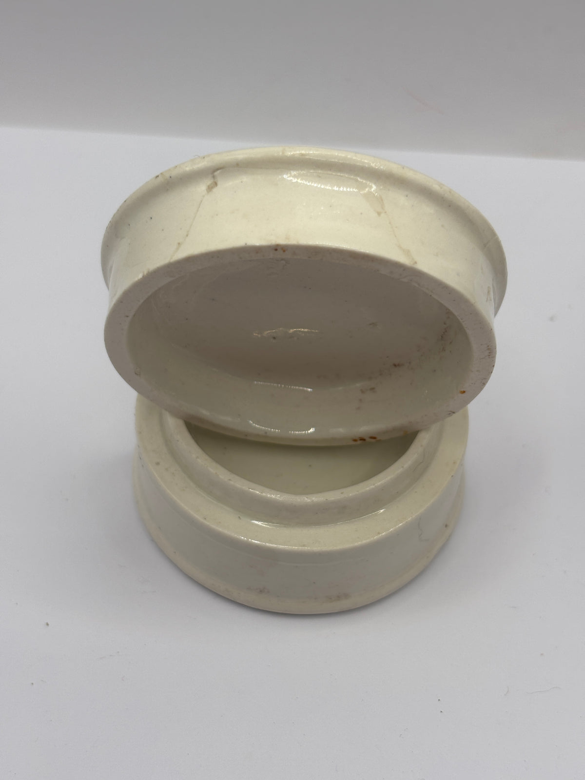 Old advertising lid and base. Woods areca nut tooth paste. Damaged