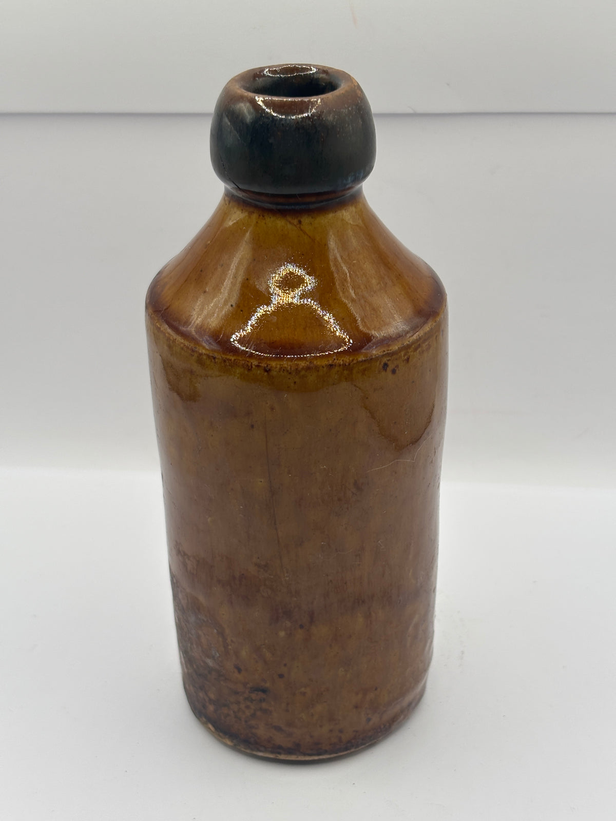Old impressed stoneware ginger beer bottle, Manchester. Brown top