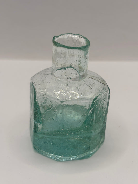 Old aqua glass inkwell, bubbly ink