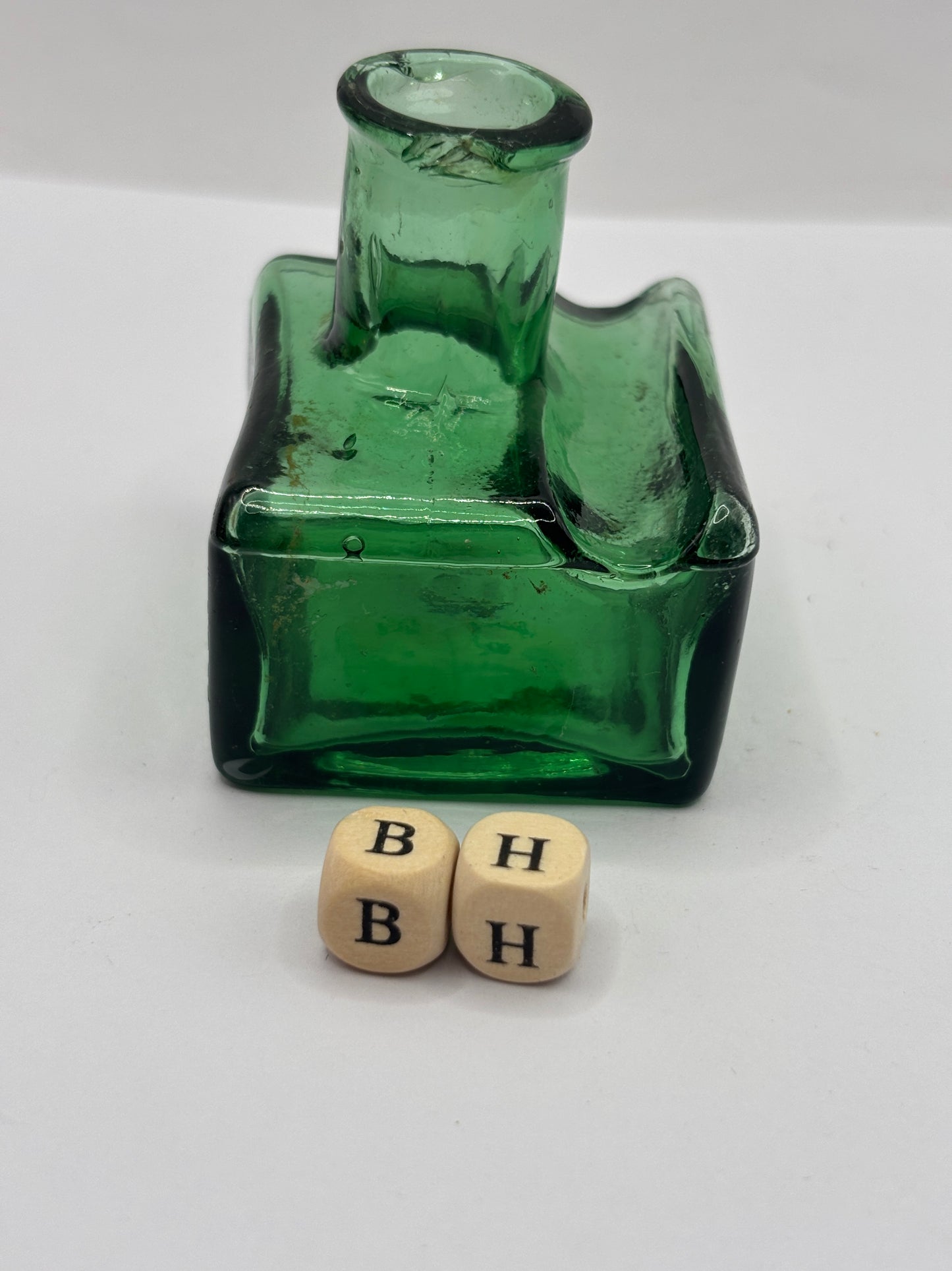 Old green glass ink bottle, inkwell. With pen rest (BH) chipped