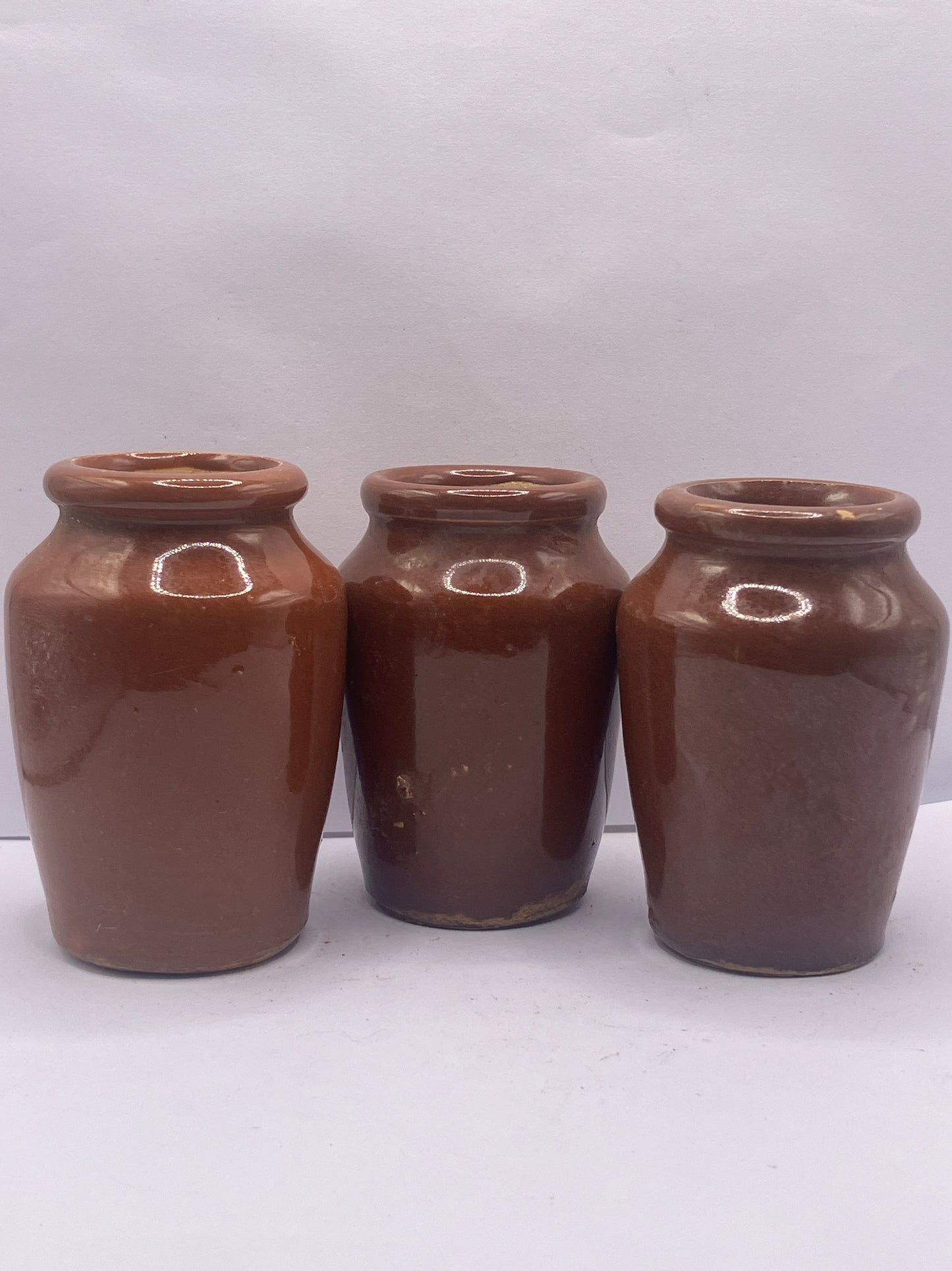 3 small brown stoneware cream pots