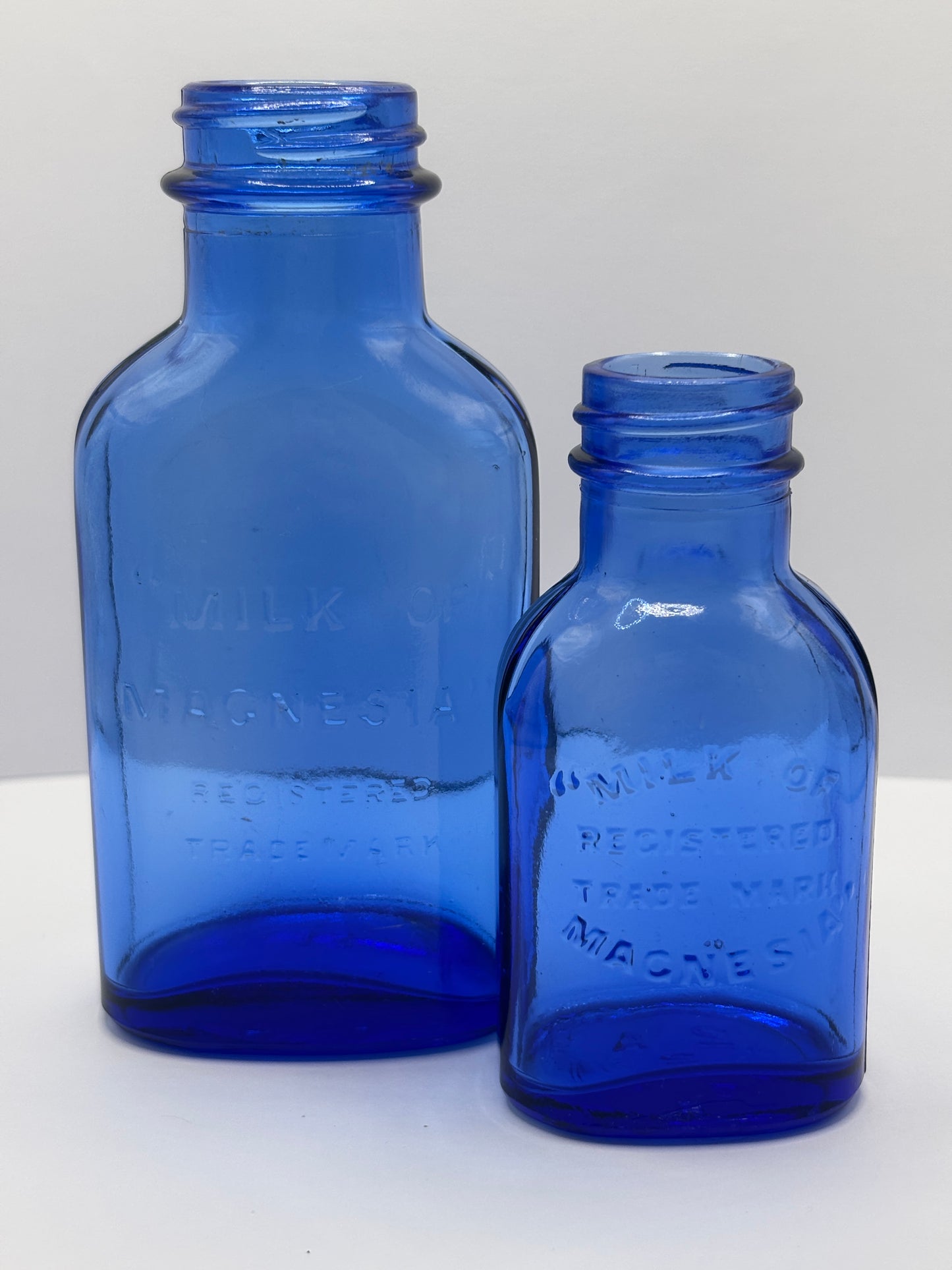 2 Blue milk of magnesia bottles