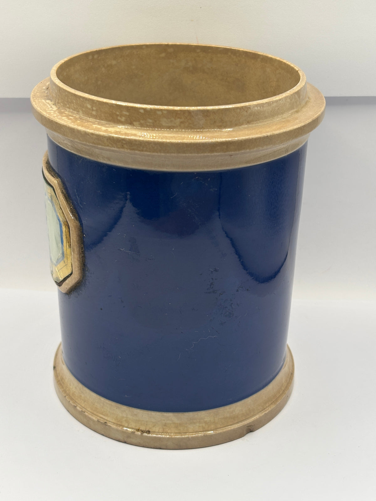Old plain blue stoneware apothecary jar with glass label