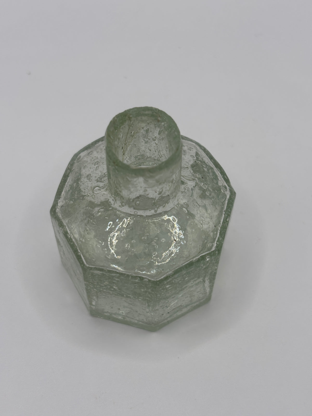 Old glass inkwell, bubbly ink
