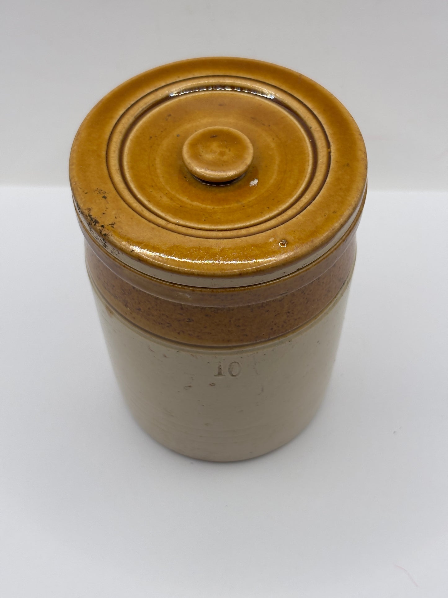 Old brown top stoneware jar and lid