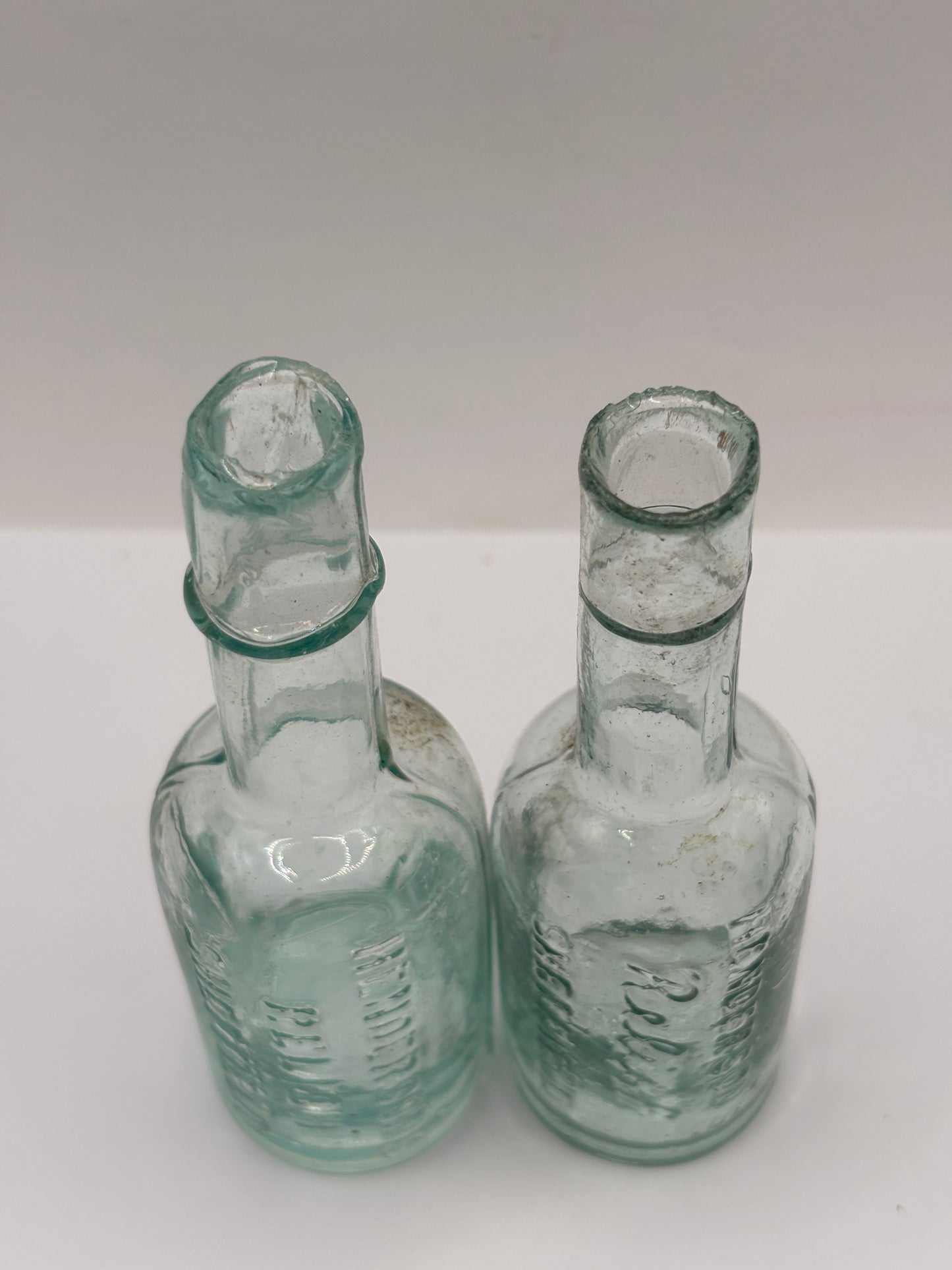 2 old aqua glass Henderson’s relish bottles