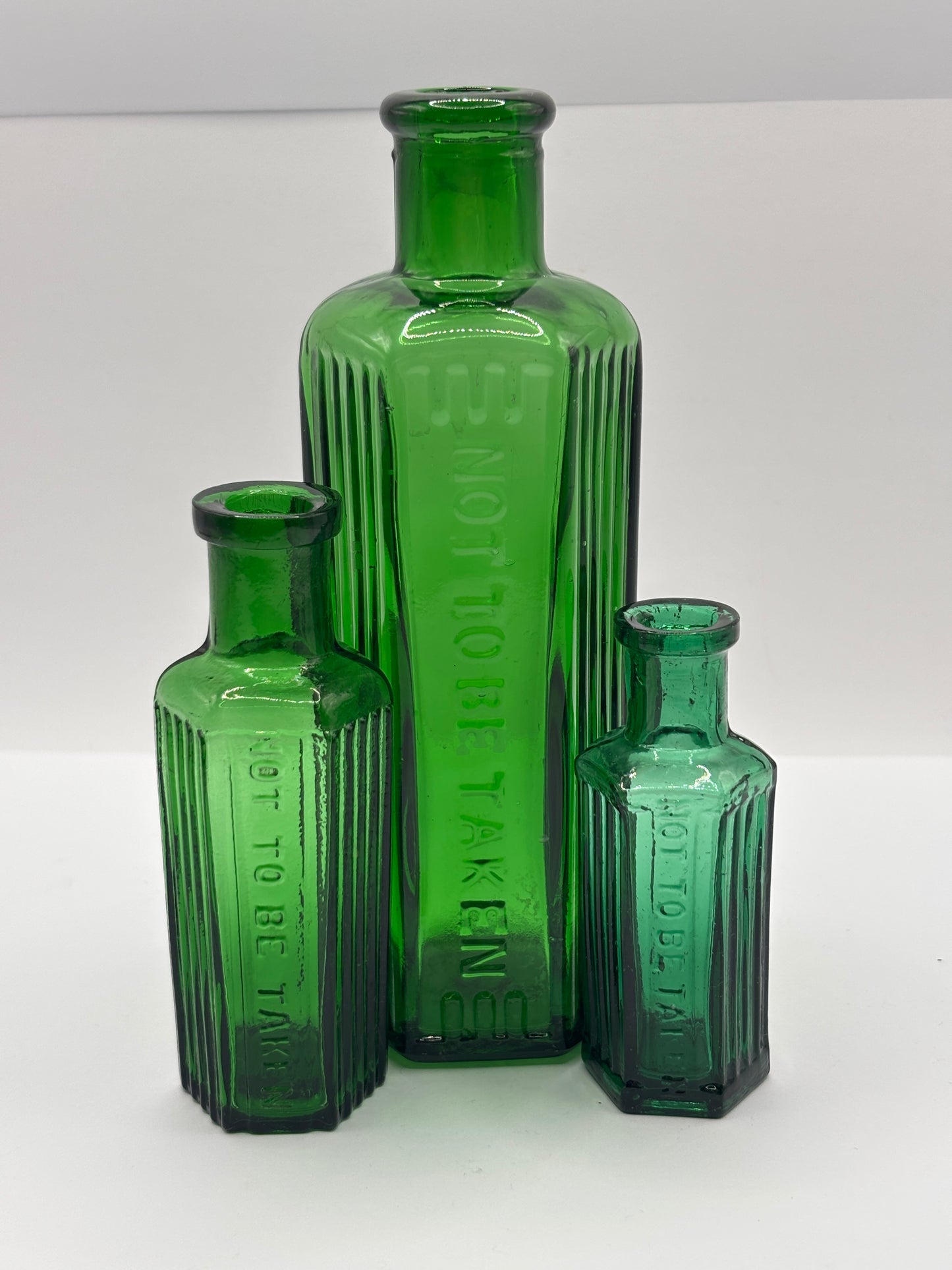3 Old green glass poison bottles, not to be taken