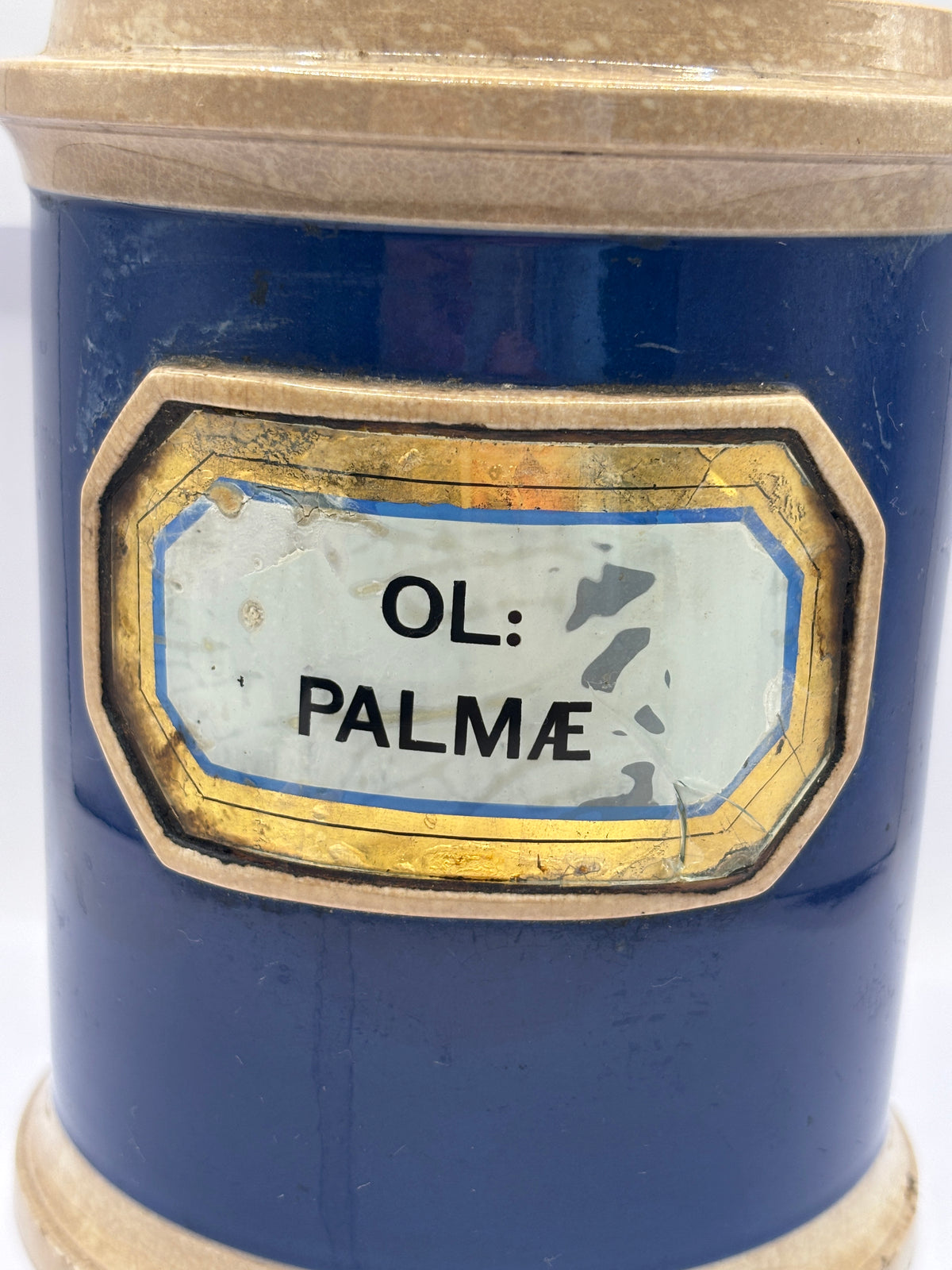 Old plain blue stoneware apothecary jar with glass label