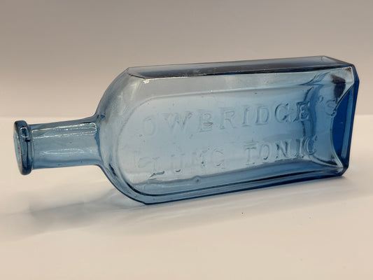 Old blue glass advertising chemist bottle, Owbridge Lung Tonic