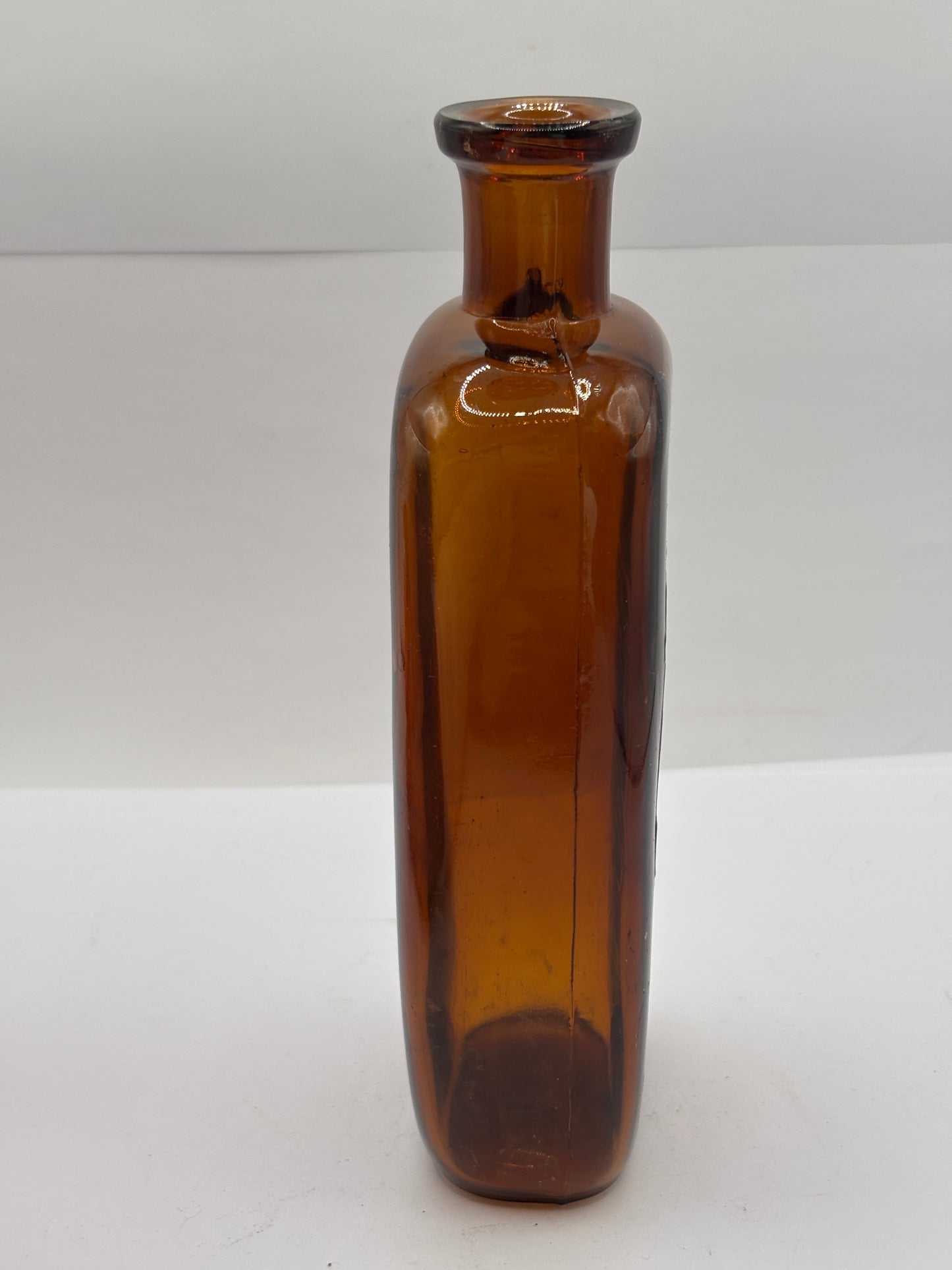 Old amber glass chemist bottle