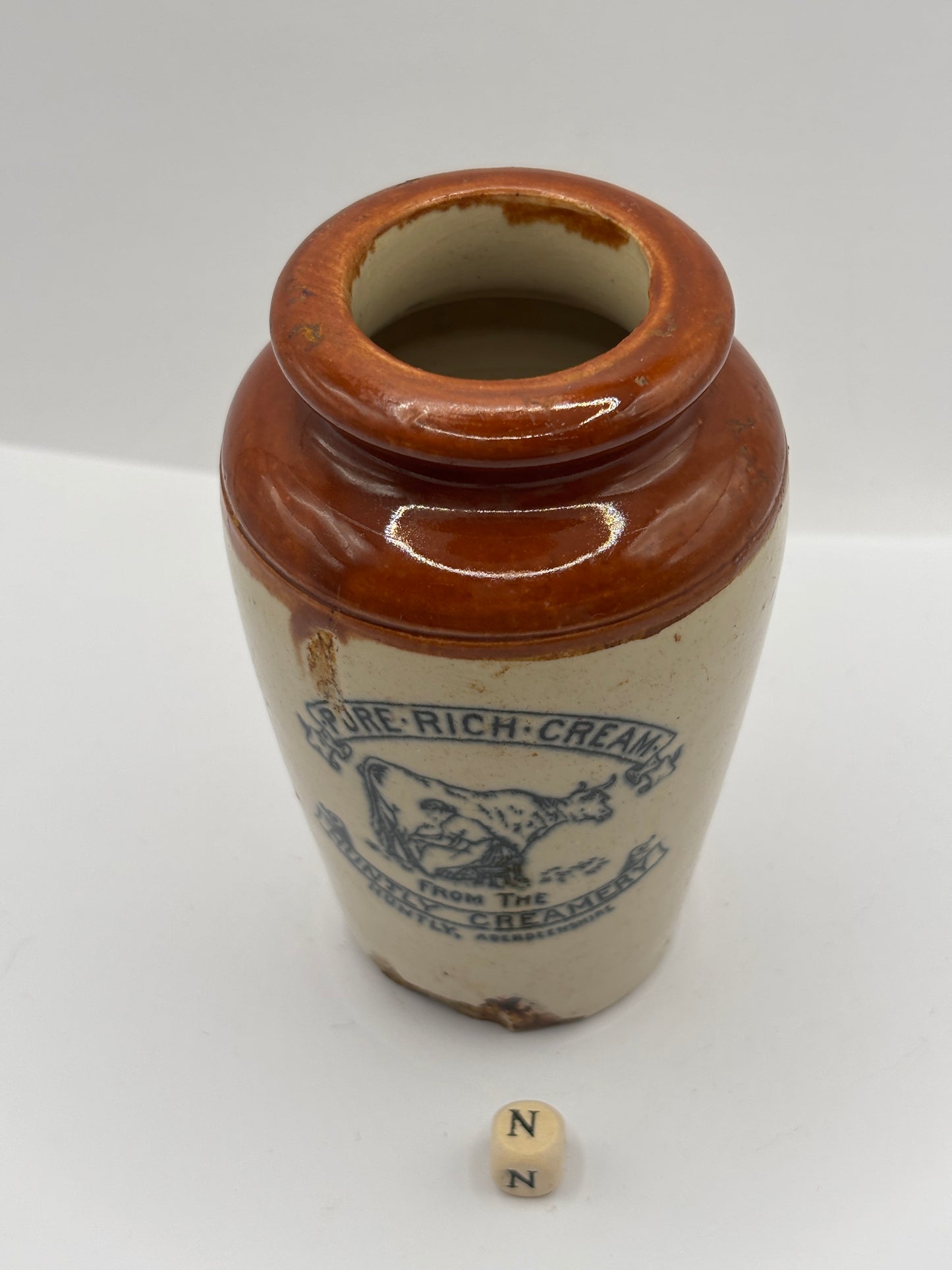 Old advertising cream pot, Huntly creamery. Milk maid. Pure rich cream. Damaged (N)