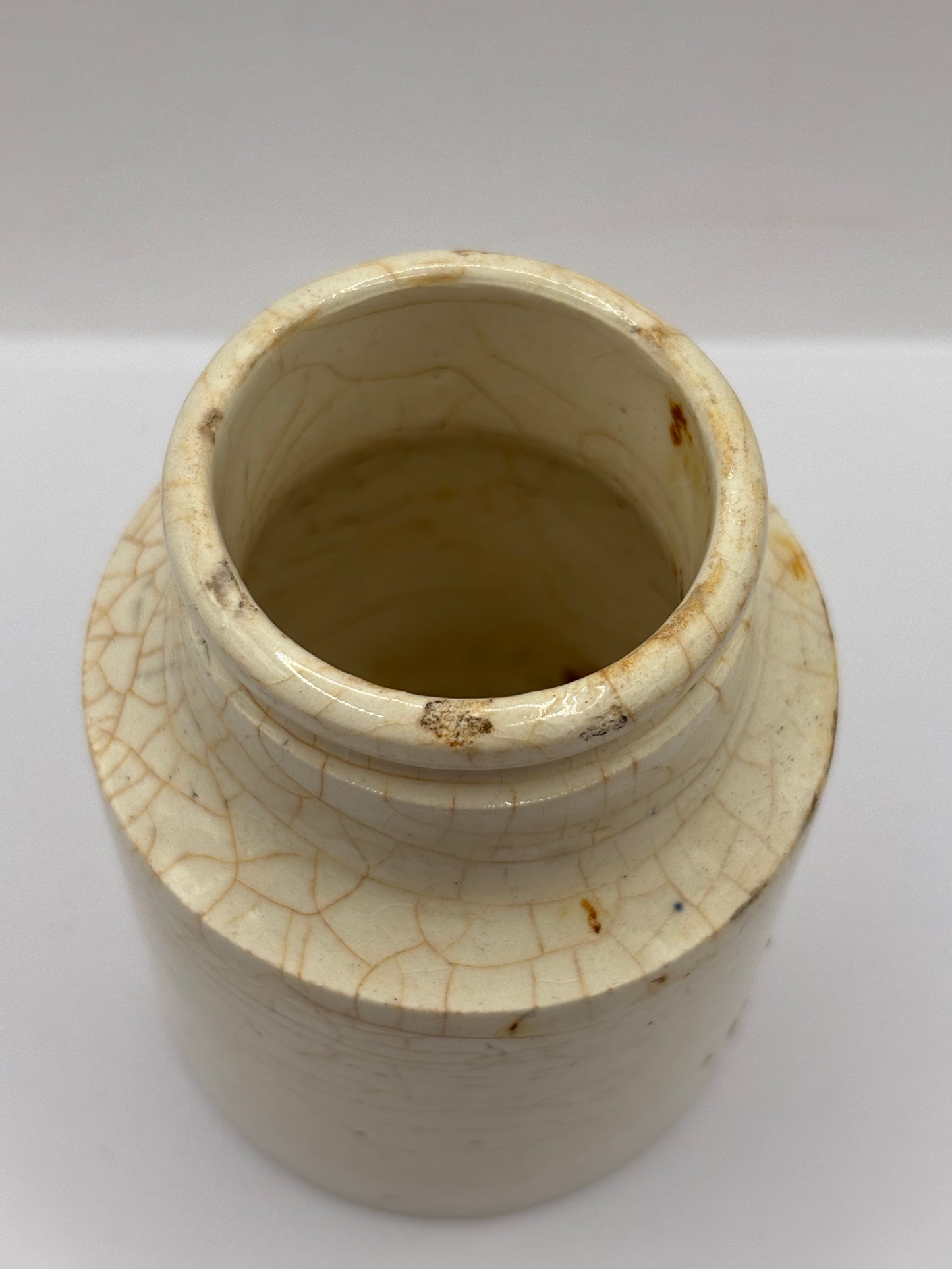 Old white stoneware jar, stained & crazed